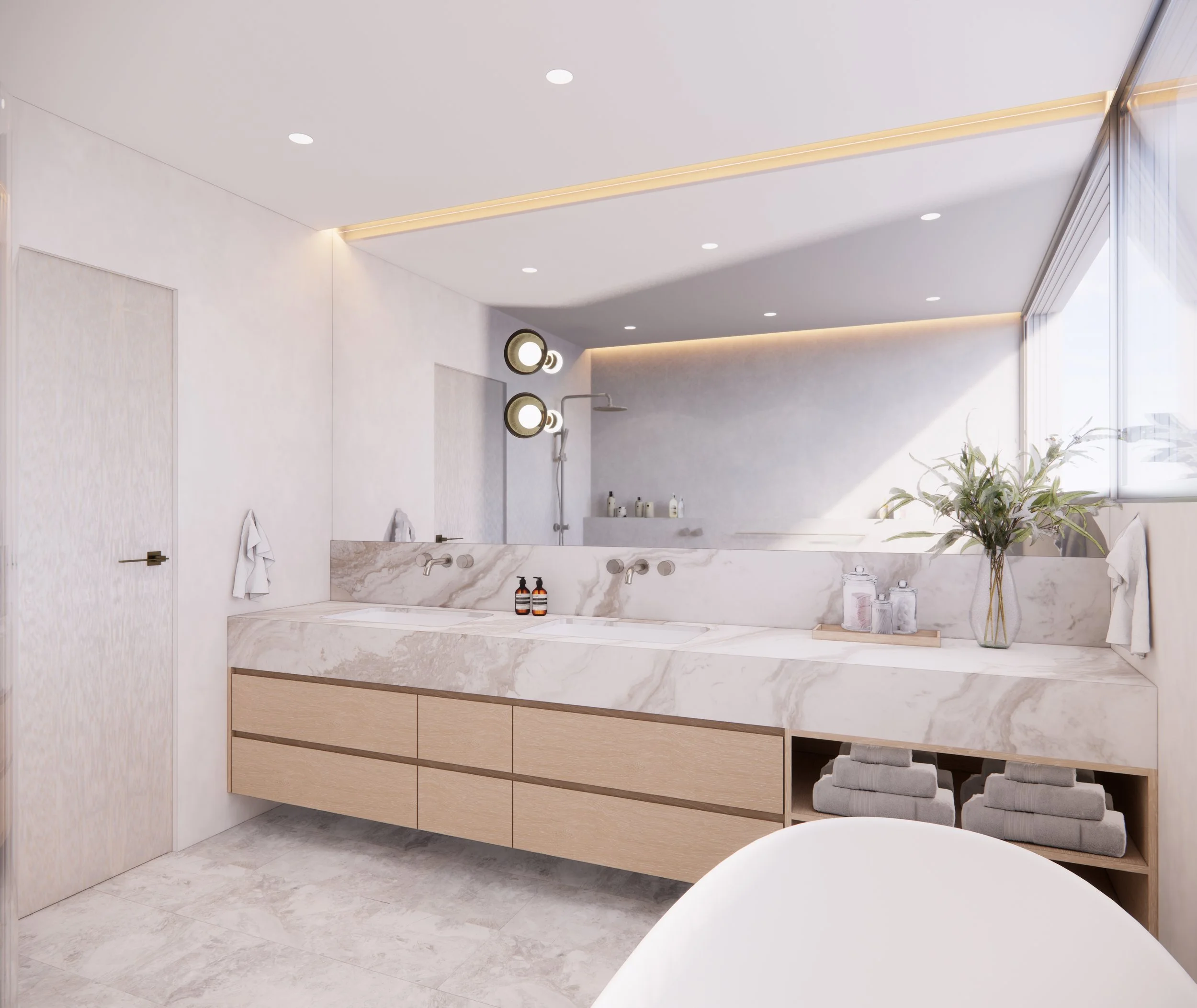 A serene, light-filled ensuite featuring warm lighting, natural stone surfaces and a minimal aesthetic by TID Studio
