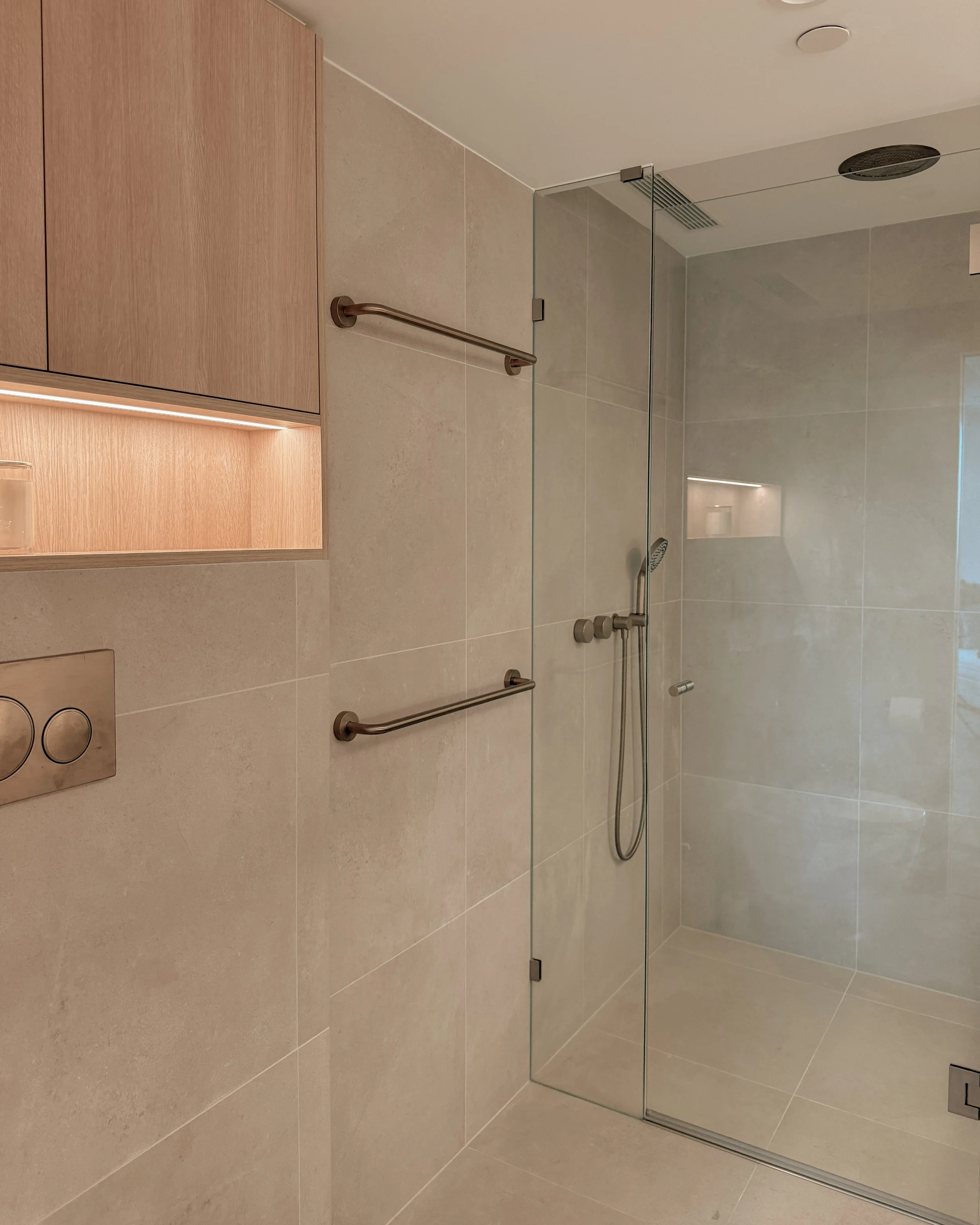 Modern bathroom with stone sink, double vanity, and warm timber tones — coastal apartment in Gold Coast designed by TID Studio Sydney