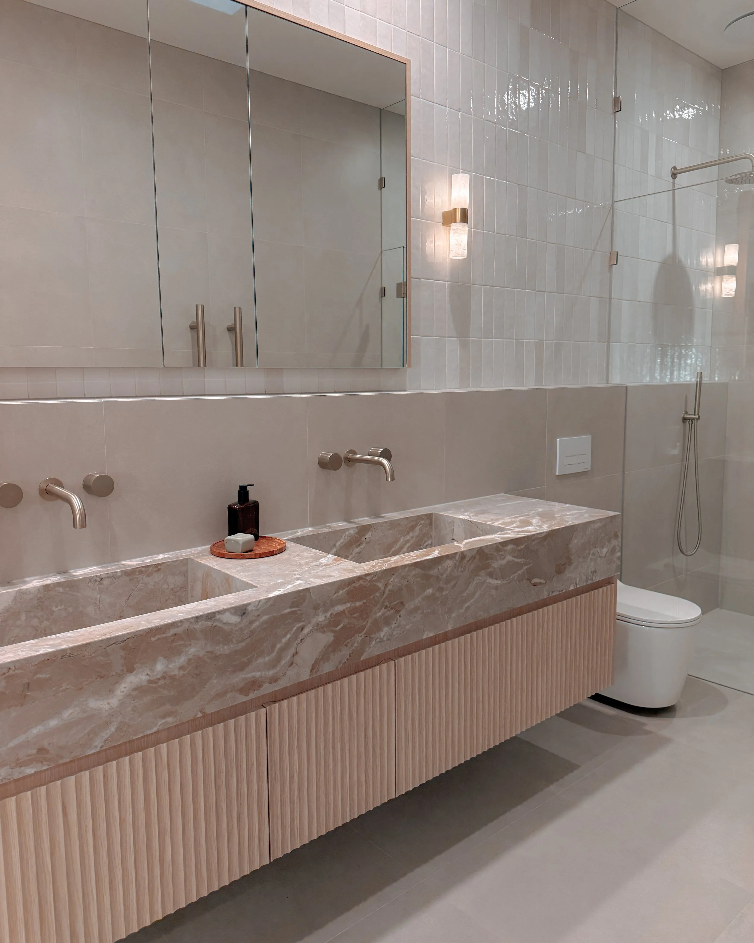 Contemporary bathroom with custom stone sink, fluted cabinets, double vanity in Melbourne new-build. Designed by TID Studio, interior design in Sydney