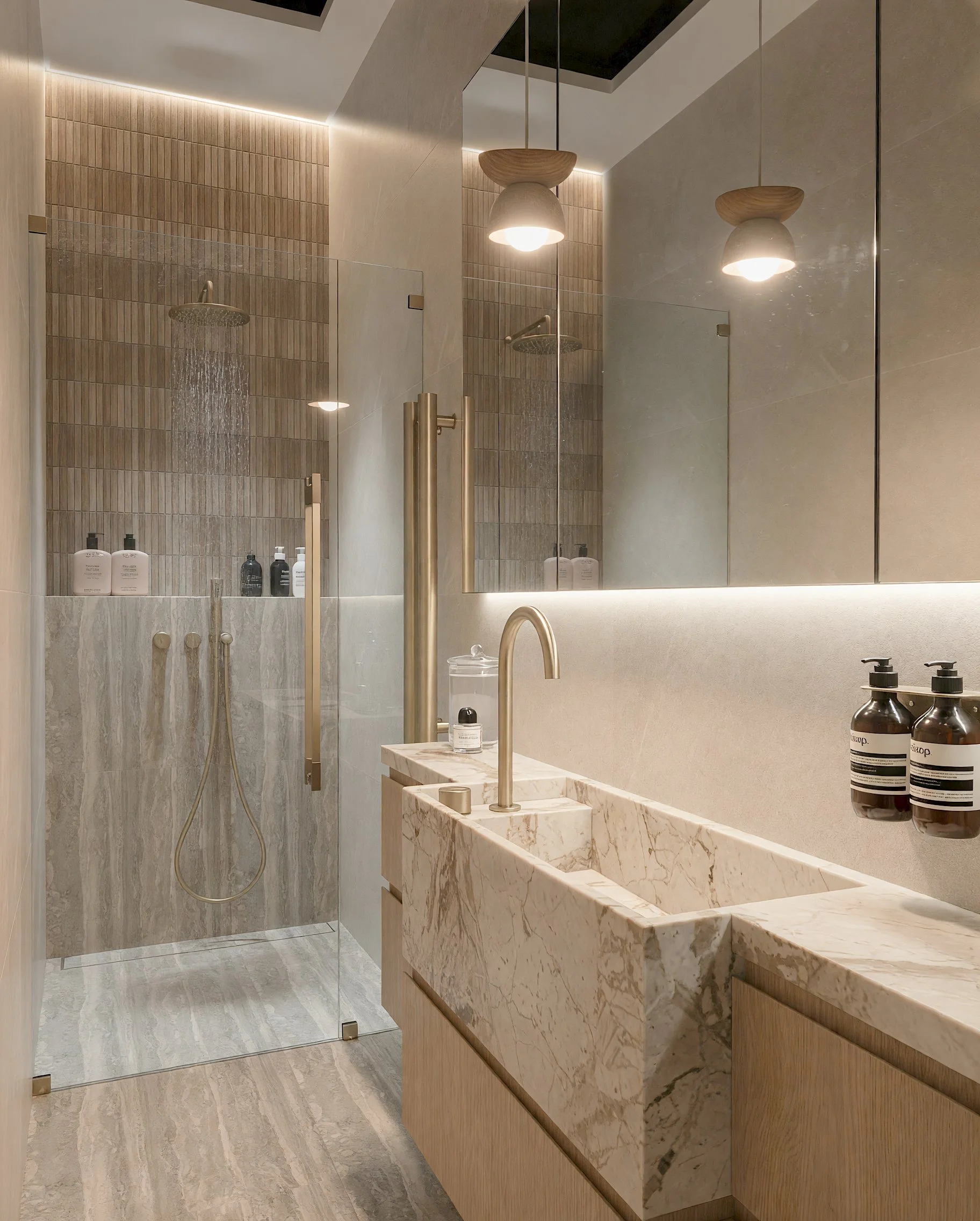 Modern bathroom with custom vanity, shower, bronze fixtures and contemporary lighting, designed by TID Studio