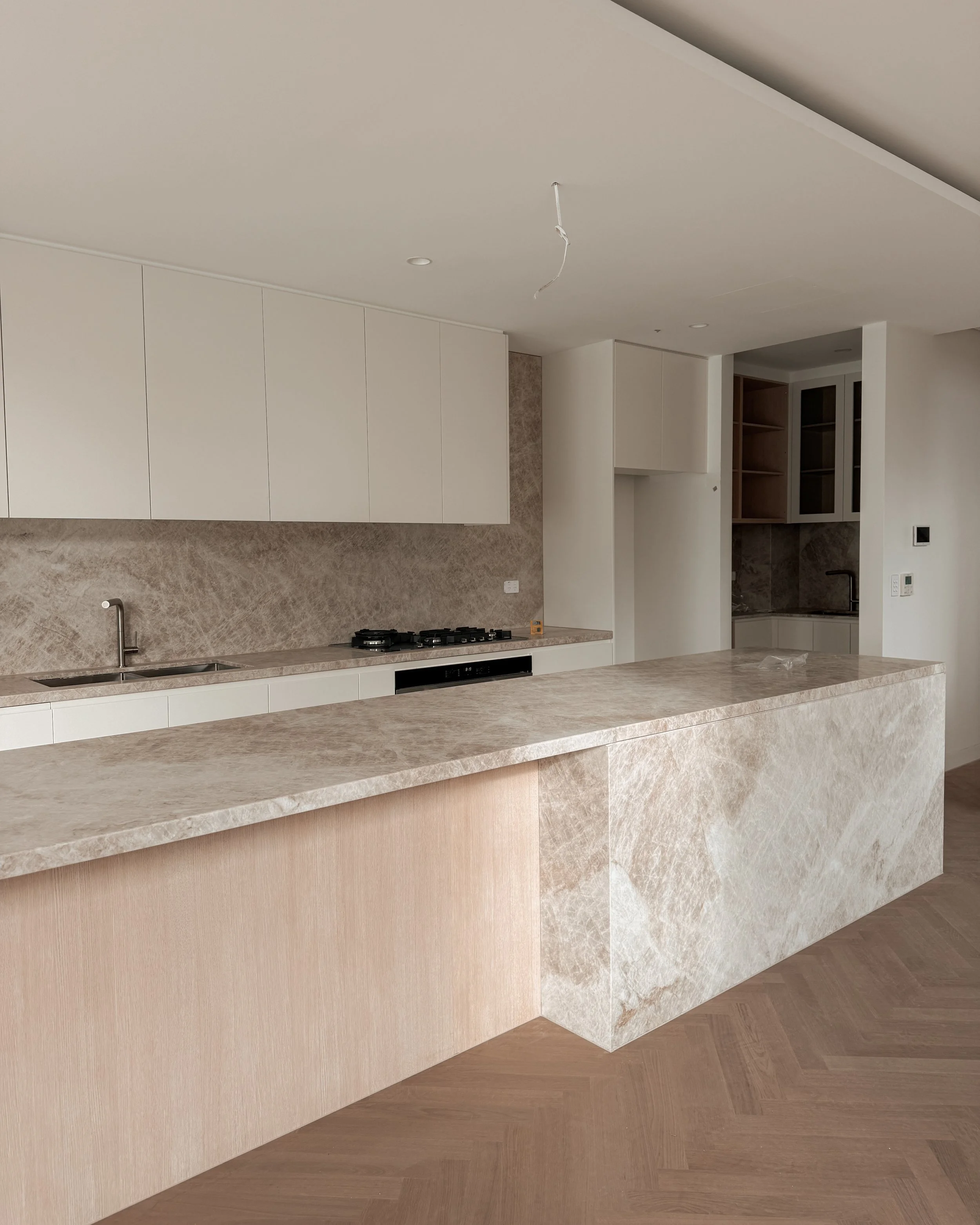 TID Studio. Contemporary kitchen design, taj mahal island, pantry, dining, bar, neutral creamy colour palette. Interior design Sydney. New build Five Dock