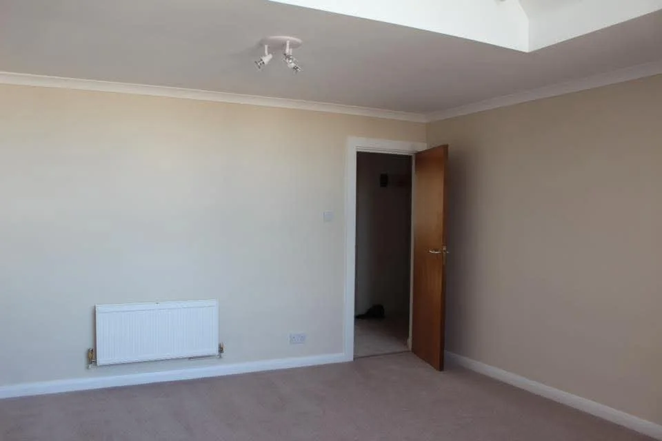Lounge with freshly painted walls crisp white woodwork and dust free finish in Guildford .