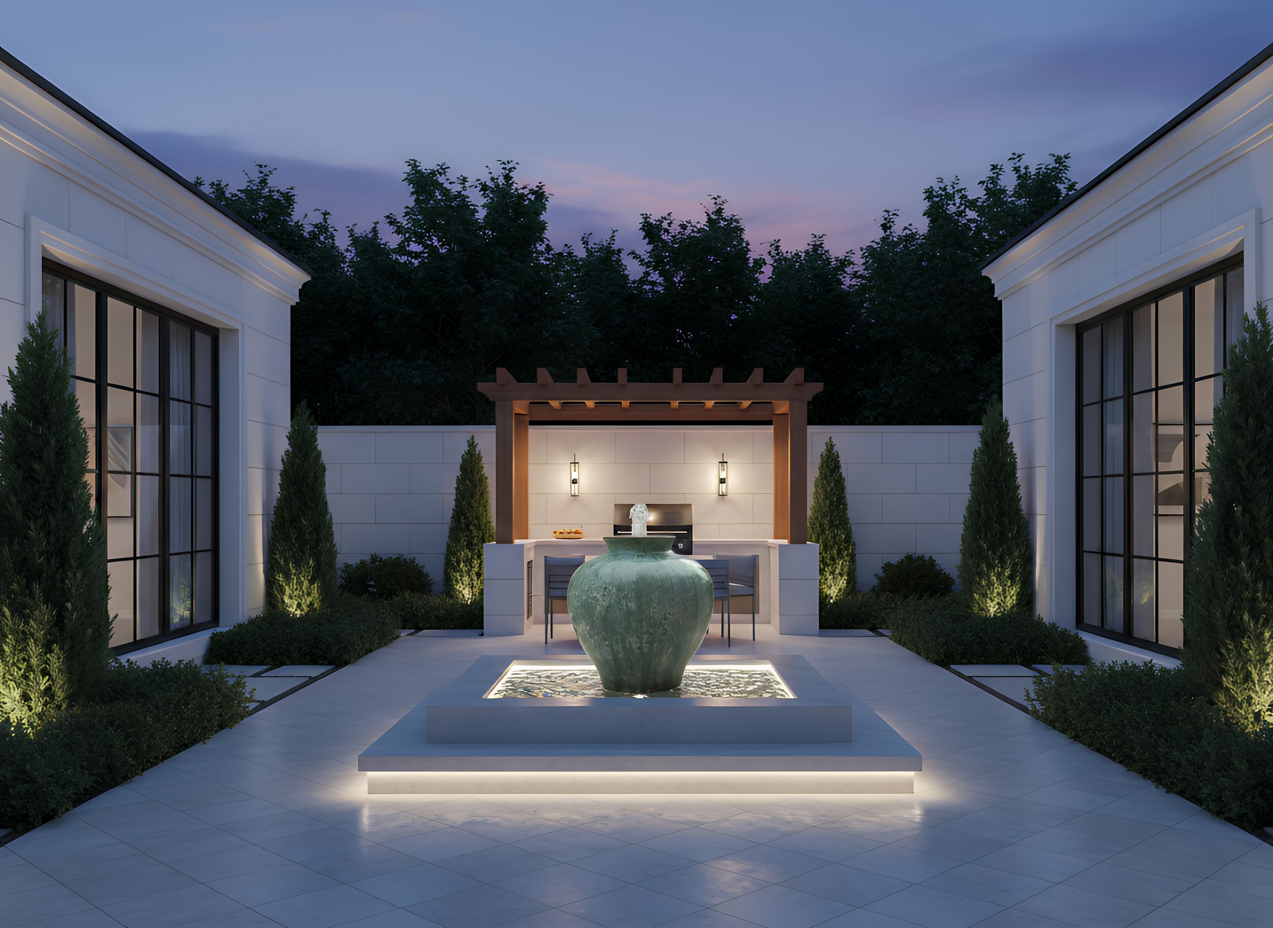 A modern outdoor patio at dusk with a central fountain, surrounded by four tall shrubs, with a small kitchen area featuring a grill and bar stools under a pergola.