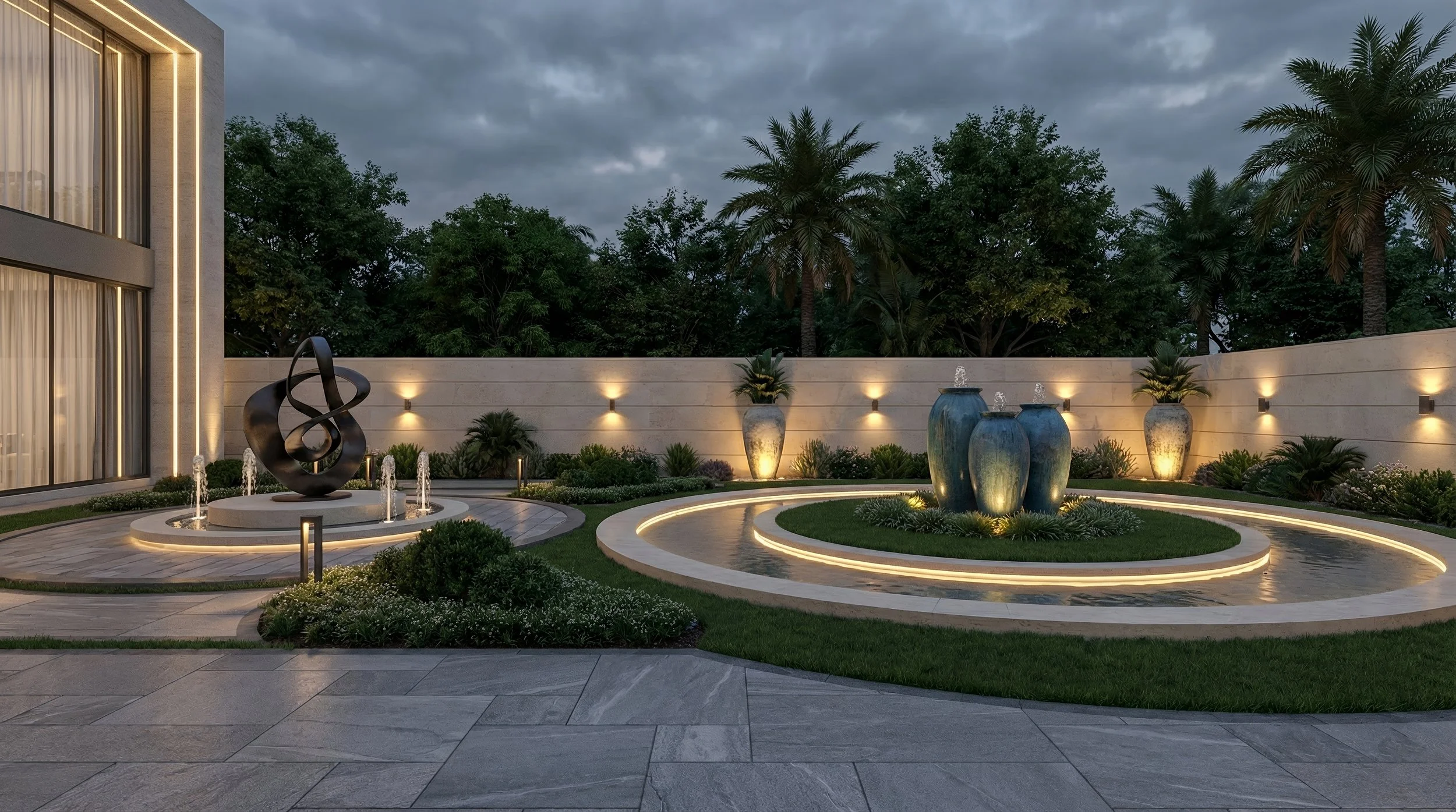 Modern outdoor patio area with three large blue decorative vases water fountains, surrounding lush green plants, palm trees, and a white stone wall with warm lighting at evening, featuring a contemporary sculpture and built-in lighting.