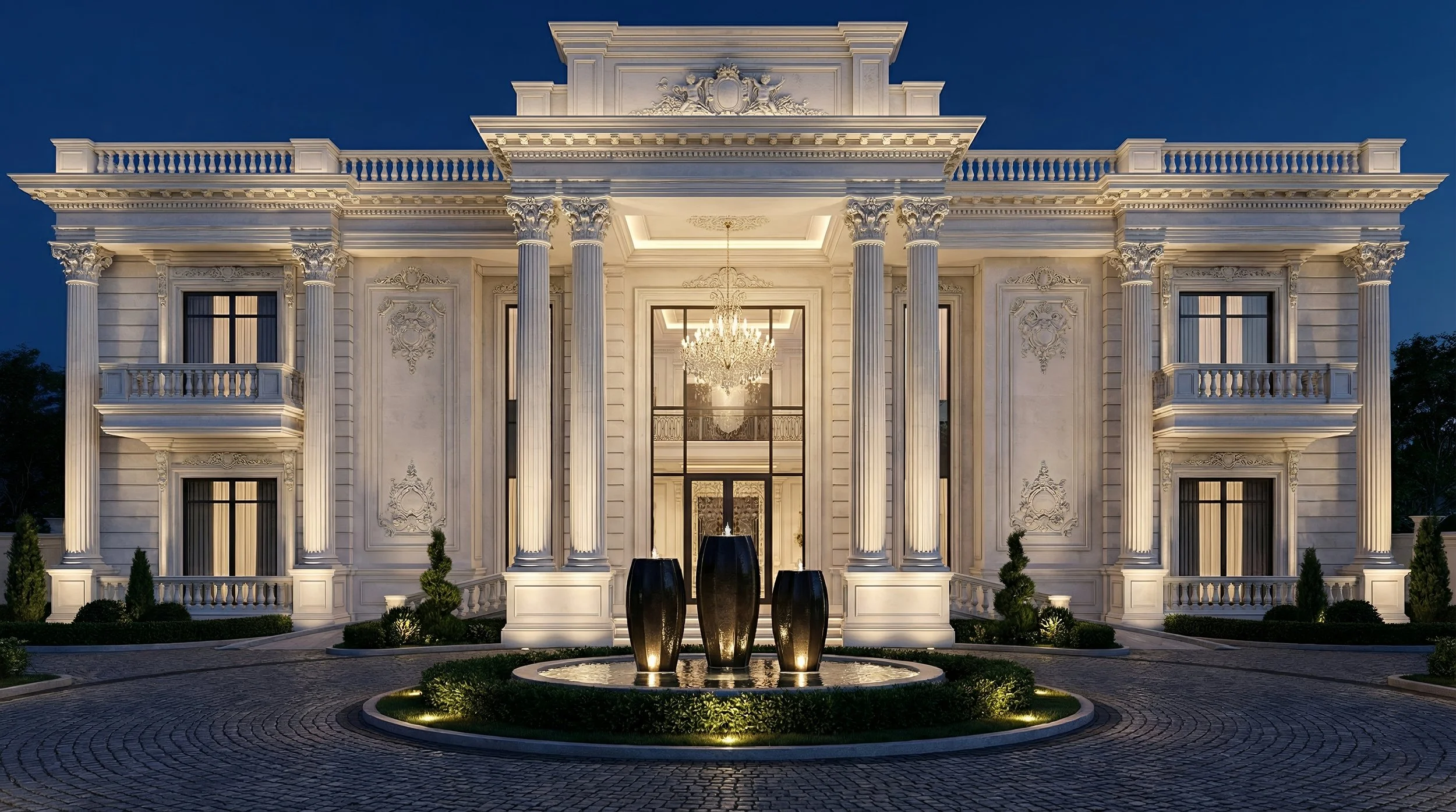 Luxurious mansion with classical architecture, tall columns, ornate details, and a grand chandelier visible through the entrance, illuminated at night with landscaped garden and water feature in front.