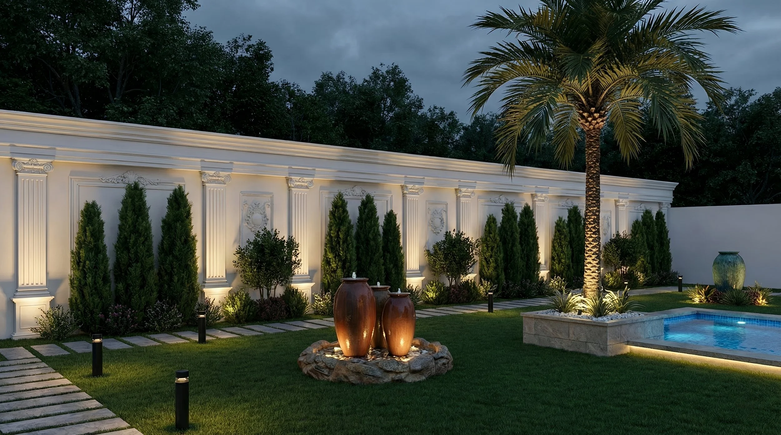 Nighttime backyard with lit decorative fountain, palm tree, swimming pool, white ornate wall with green shrubs, large planter, and landscaped garden.