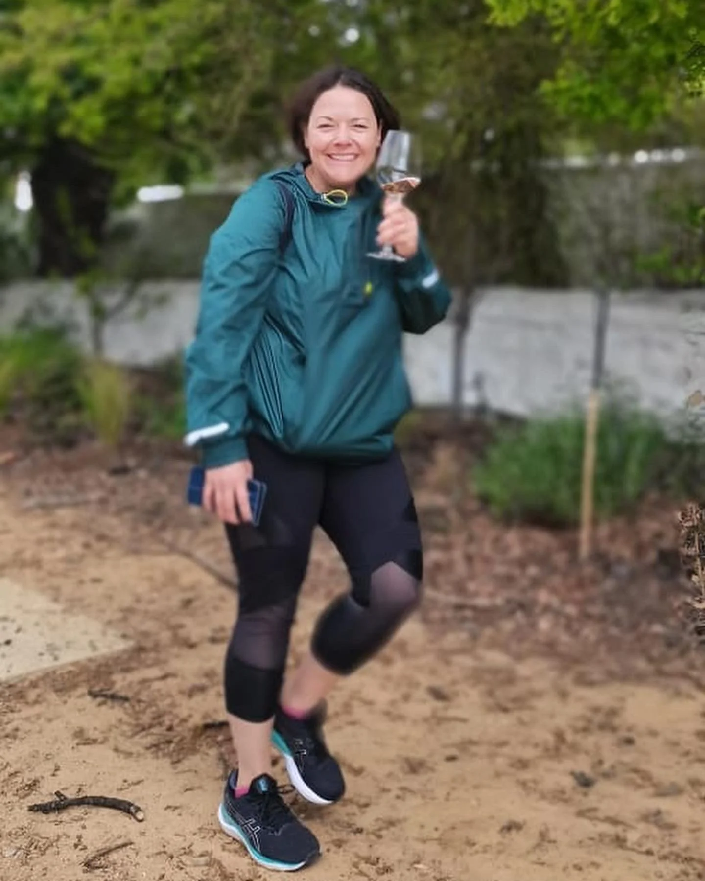 Claudia Pritchard holding a glass of wine after a cycle around the vineyards.