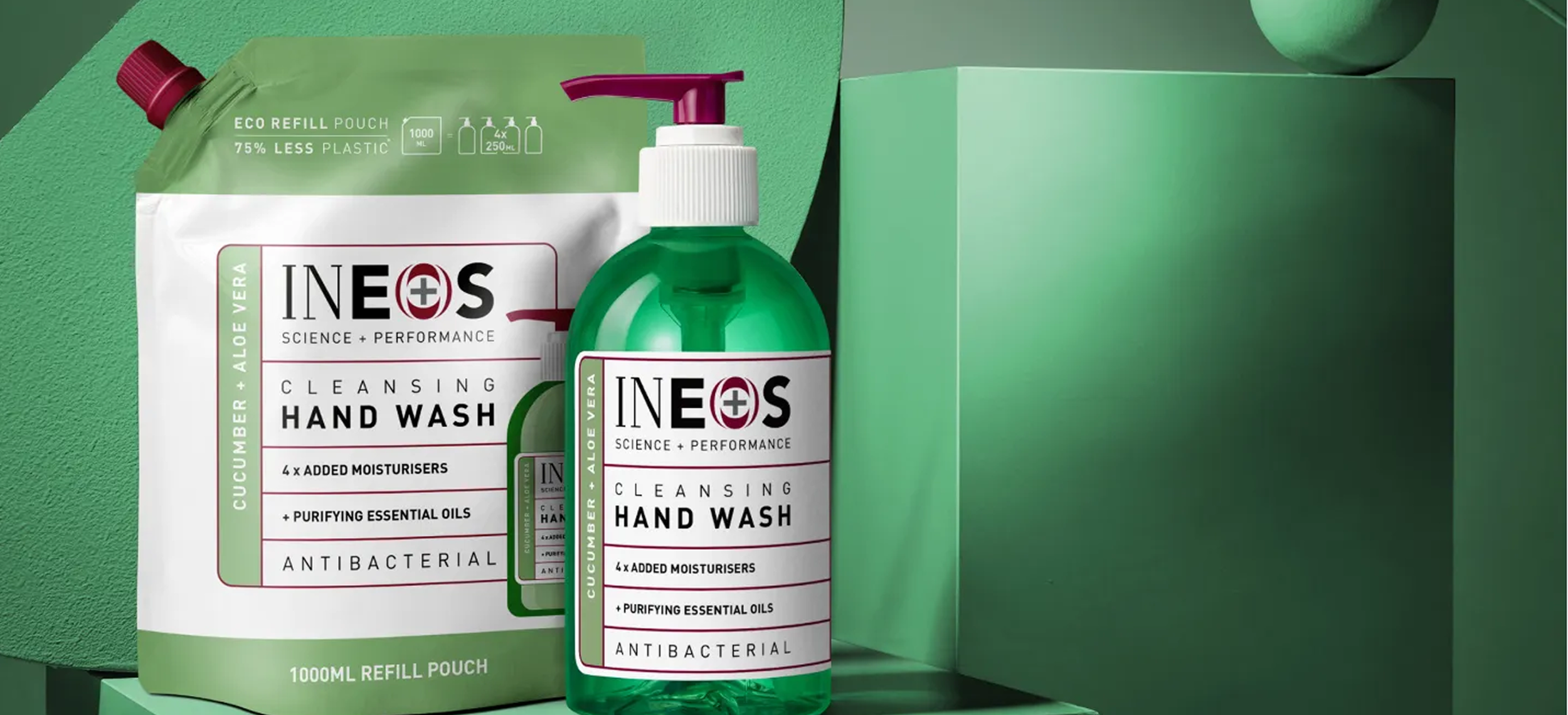 A green bottle of INEOS cleansing hand wash with a pump dispenser and a refill pouch labeled cucumber and aloe vera, on a green background with a green box.