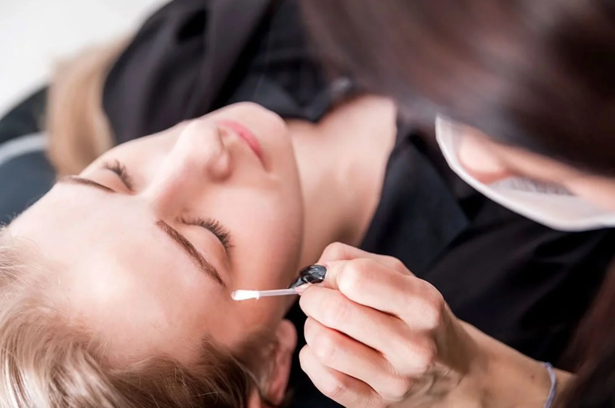 Woman receiving brow lamination treatment