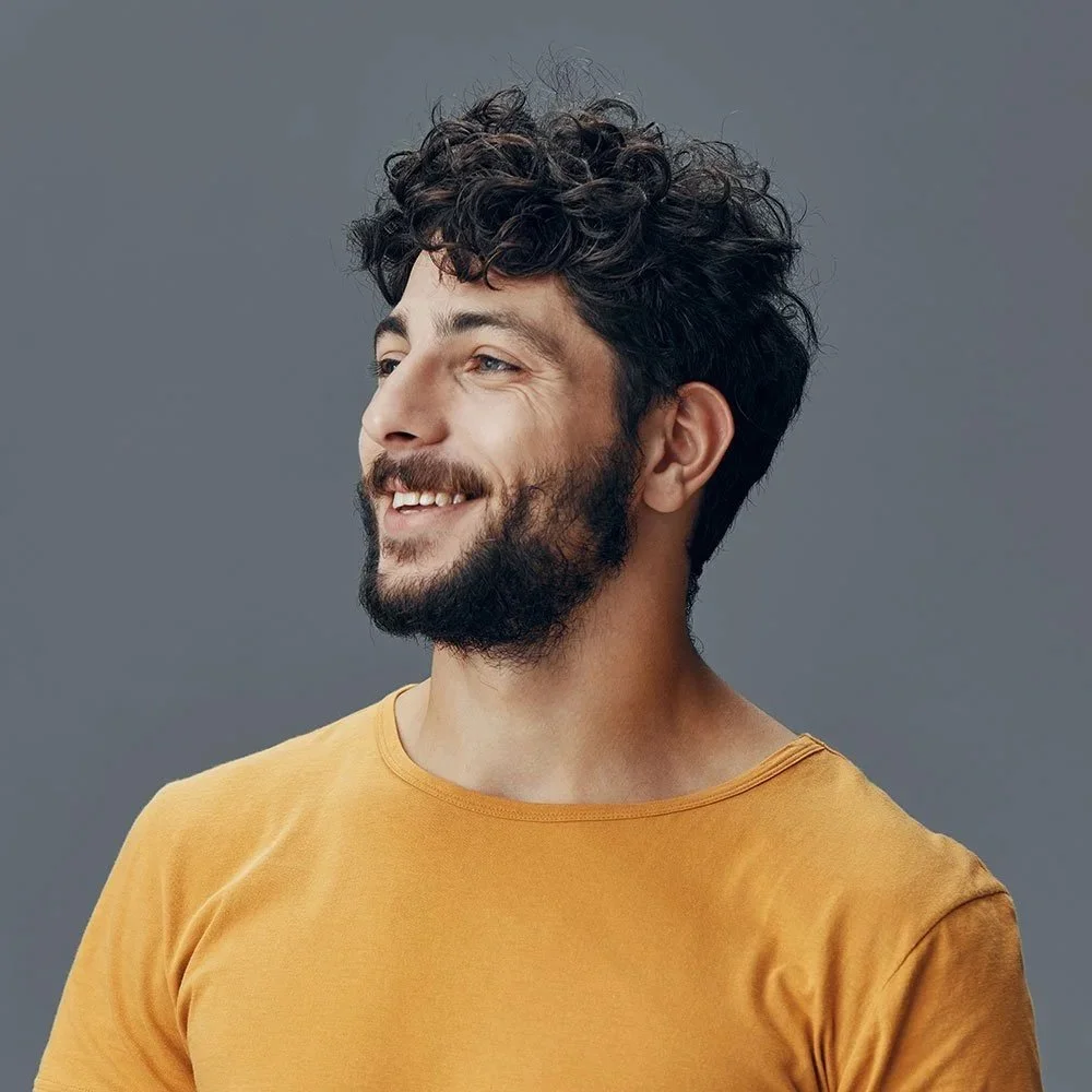 Man smiling after hair loss treatment in Staffordshire