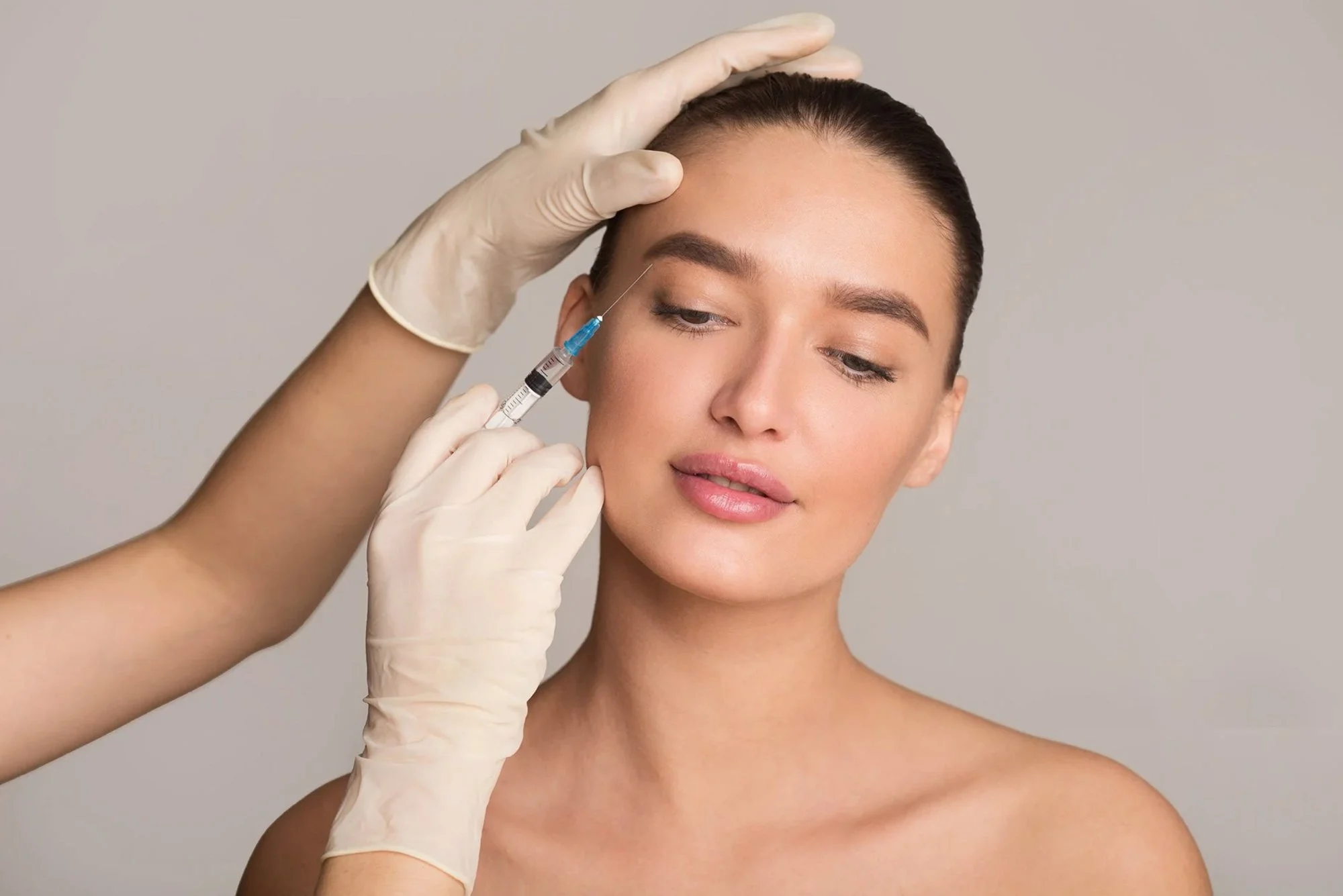 Woman receiving anti wrinkle injection in face