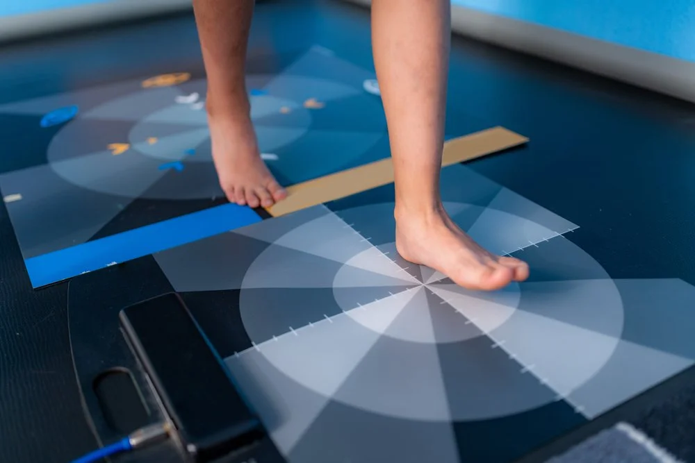 Close-up of a person's feet walking on a color calibration chart or graph with circular and segmented patterns and color patches for calibration purposes. Gait analysis