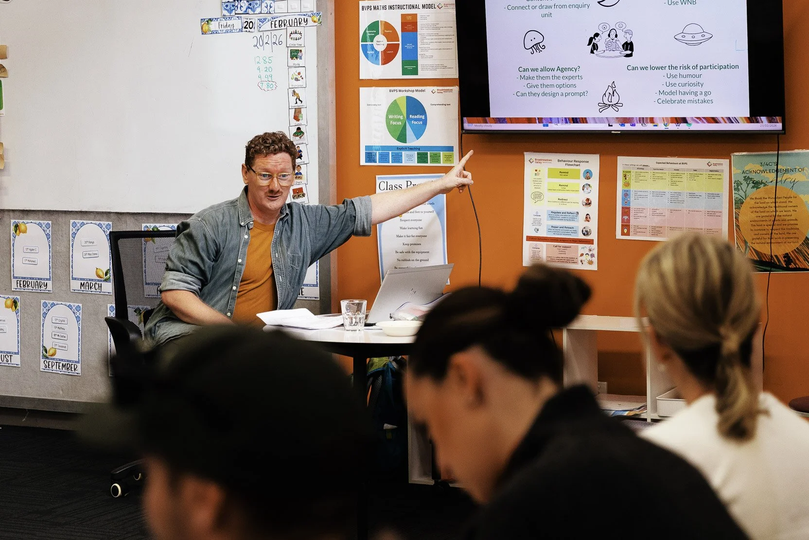 Simon Conlon gestures to a powerpoint slide about Creative Facilitation in front of teachers at a PL Workshop