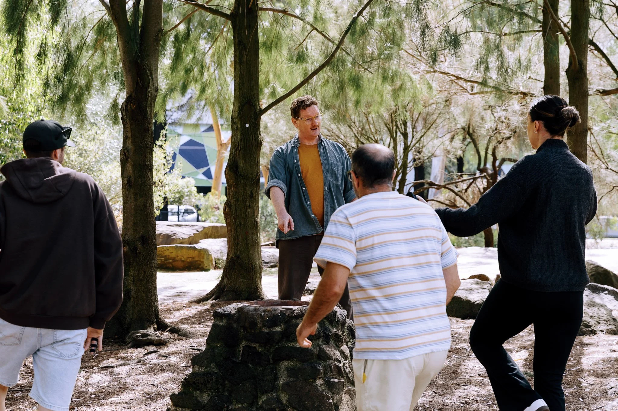 Simon Conlon facilitates a PL workshop outside amongst trees with teachers