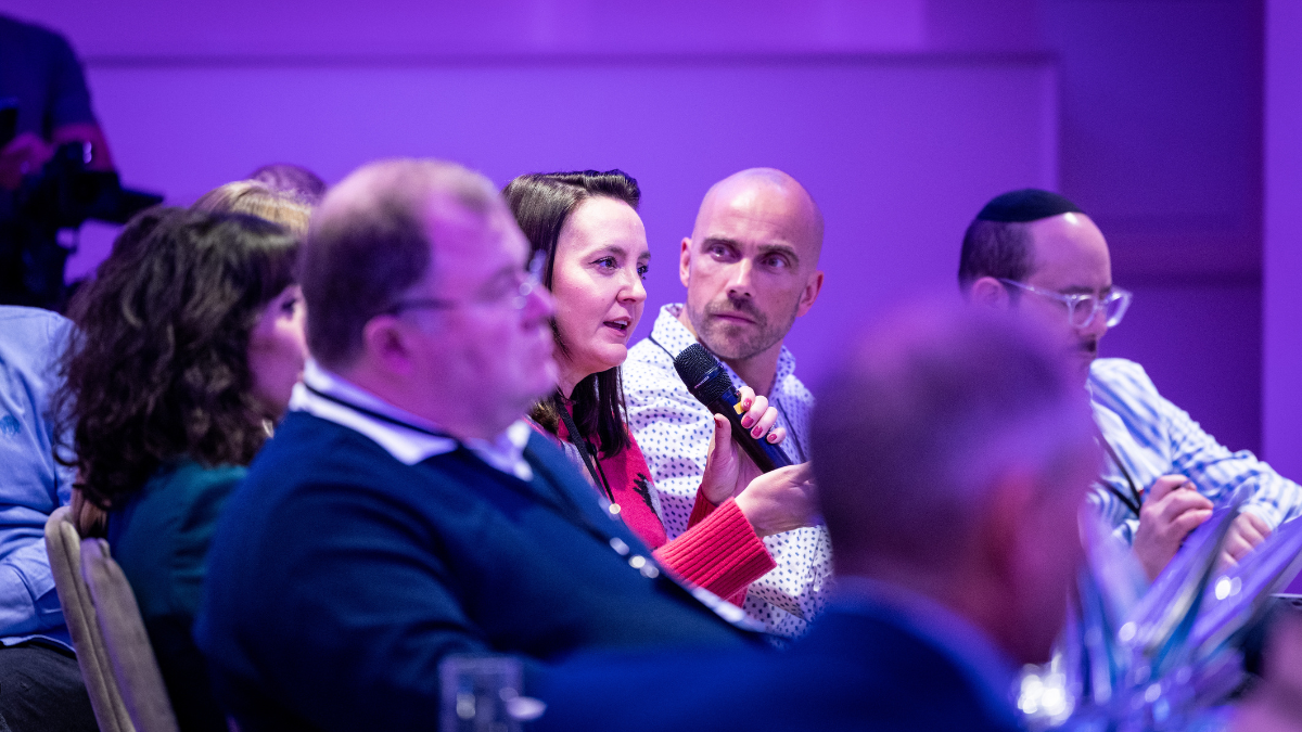 Rebecca Robinson with the microphone surrounded by Mark Roberts, David Levine and other professionals of the UK Space sector at the UK Space Agency Accelerator Trajectory event in London