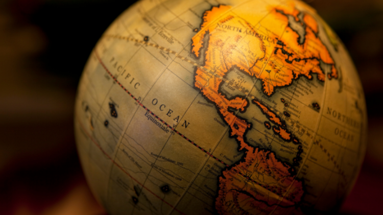 A small globe showing North and South America with labeled continents and oceans.