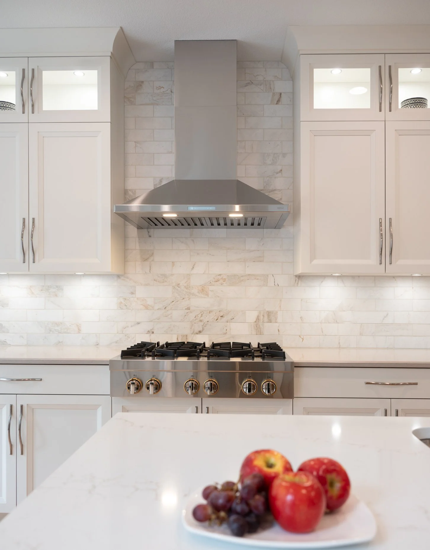 Stunning White Kitchen with floor to ceiling backsplash and lighted cabinetry