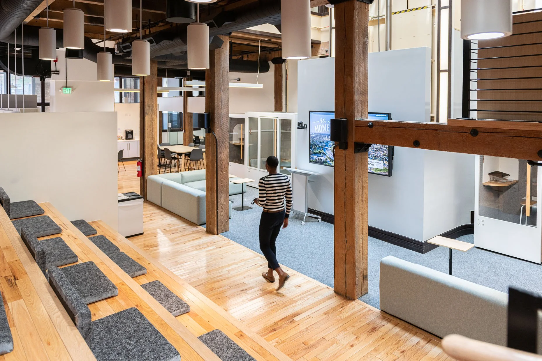 Design/Build workspace modern design and community area with lifestyle of man walking through