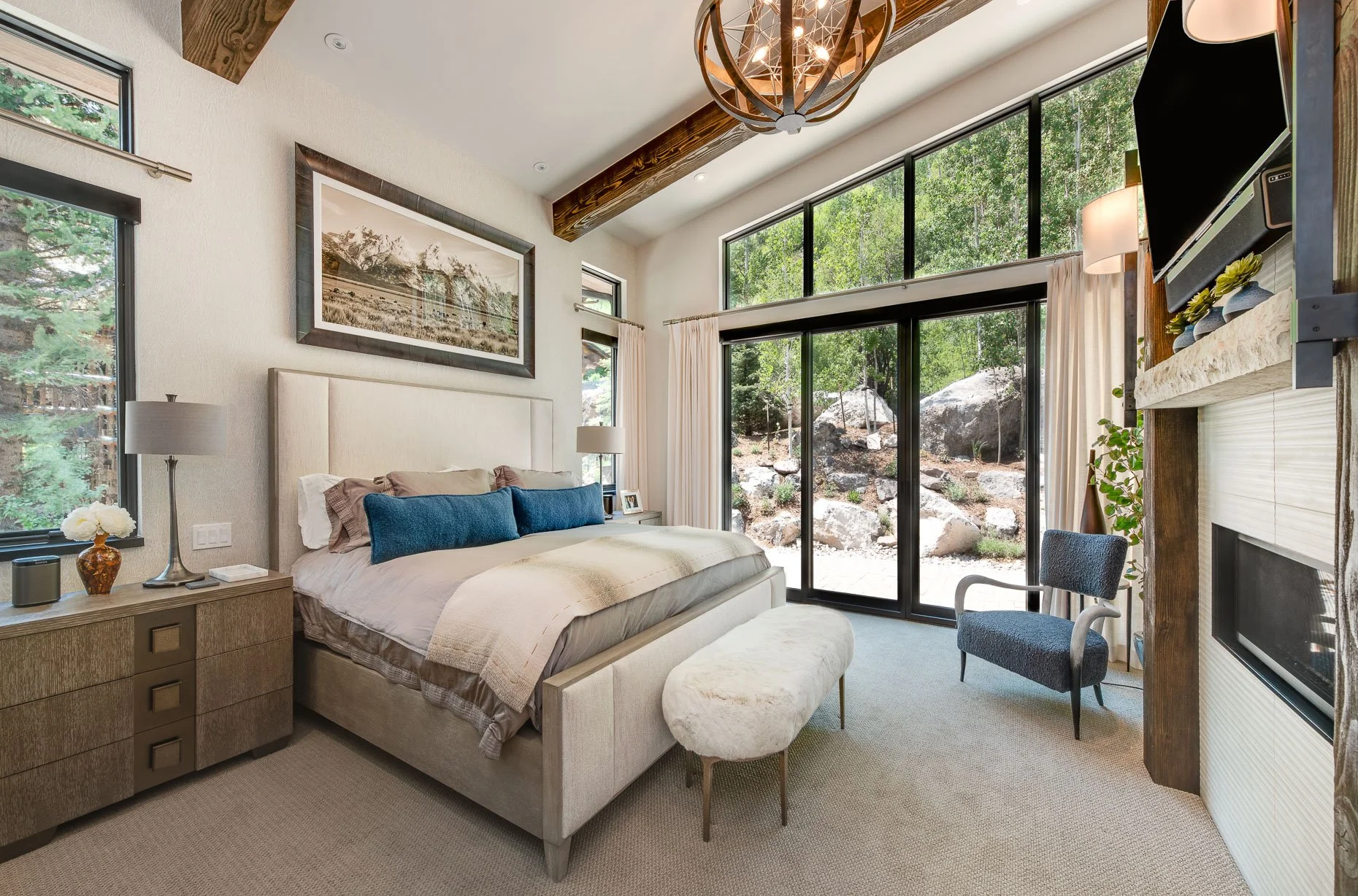 Mountain Primary Suite with soaring ceilings and open windows