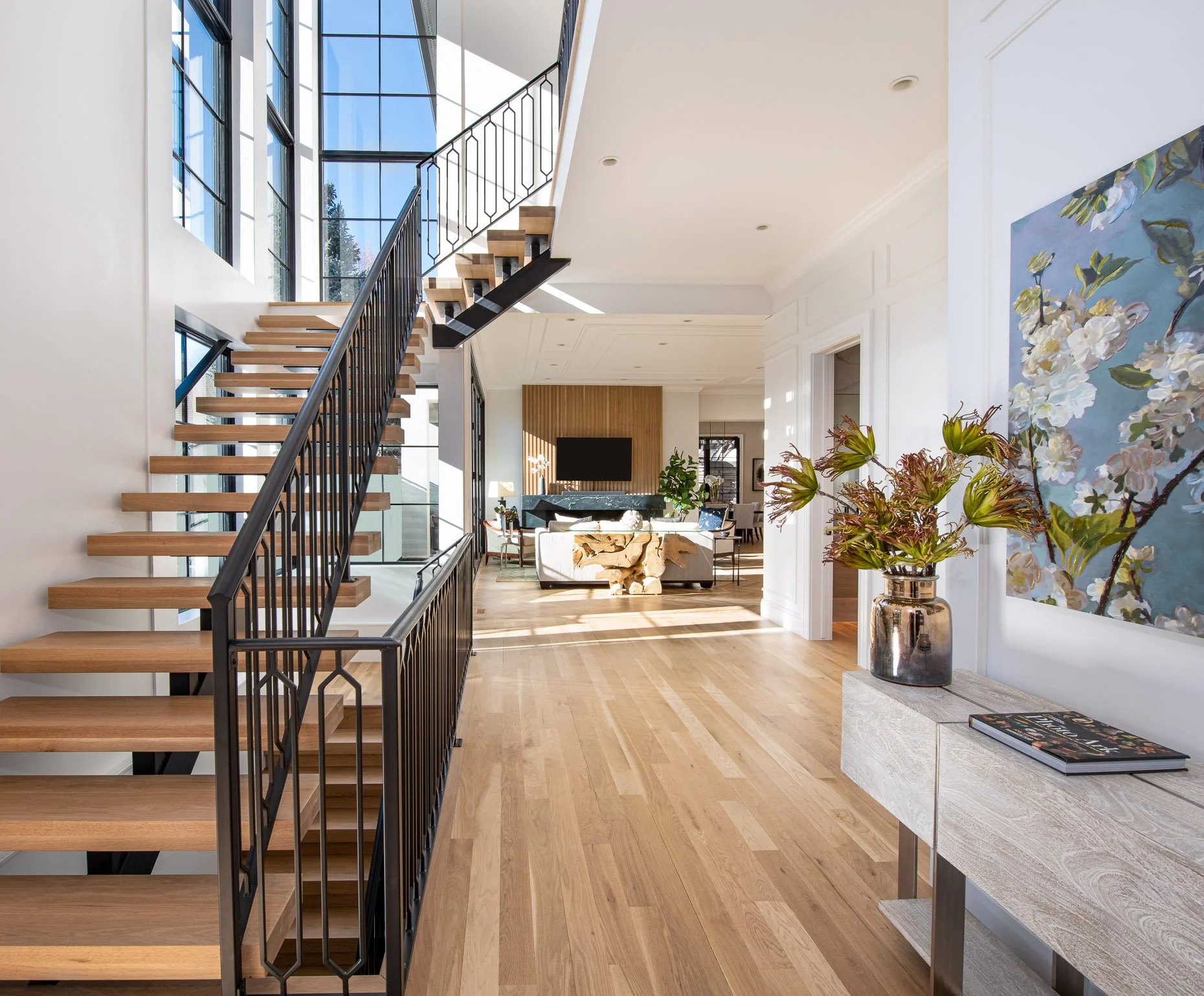 Extraordinary Foyer Design with custom staircase and large windows