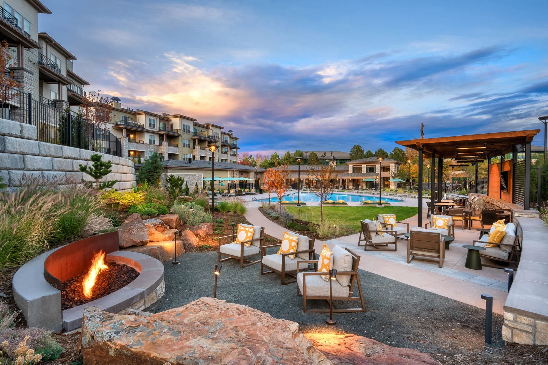 Pool and Firepit area in newly built apartment community with professional landscaping