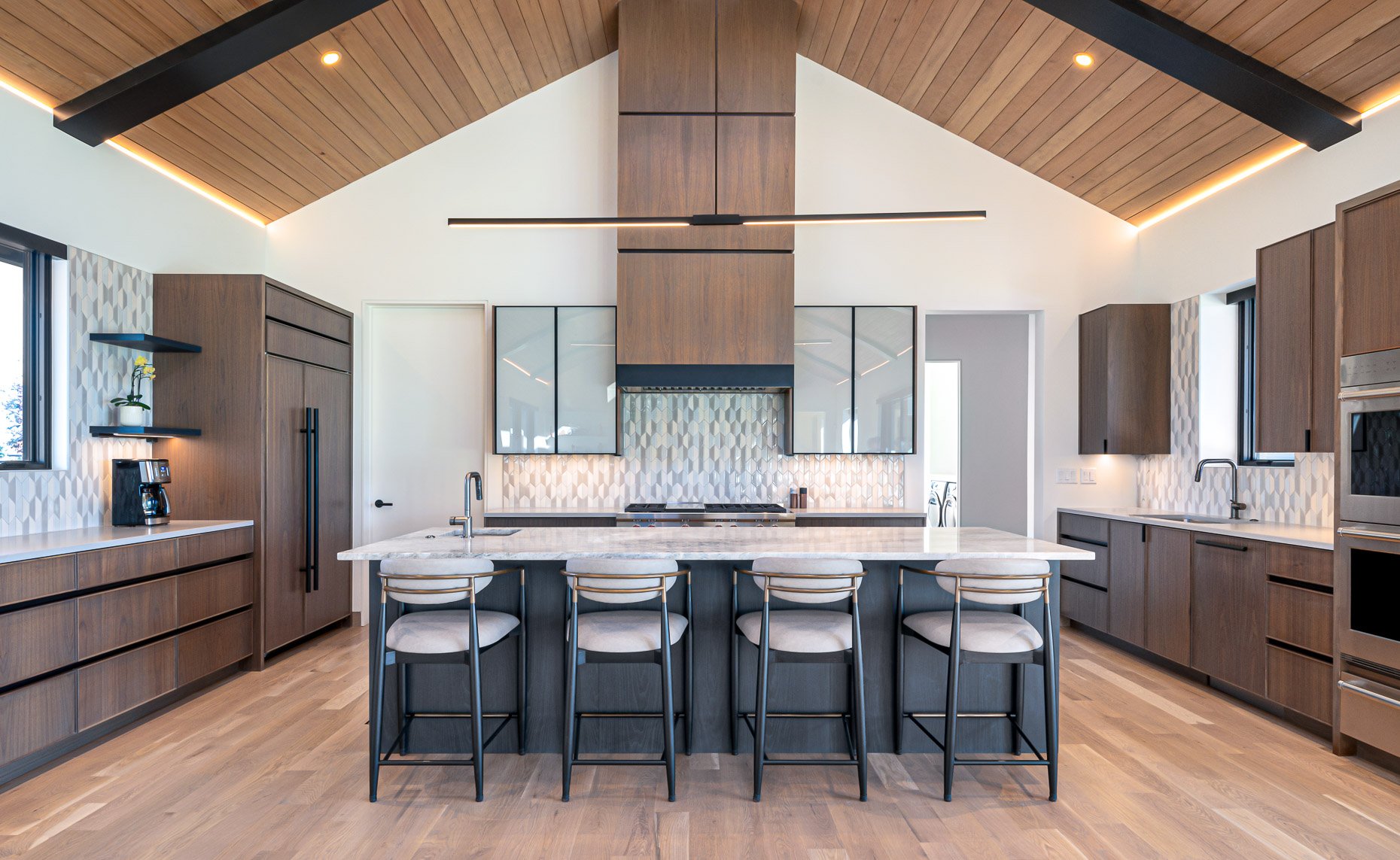 Modern kitchen design with soaring wood ceilings and contemporary design