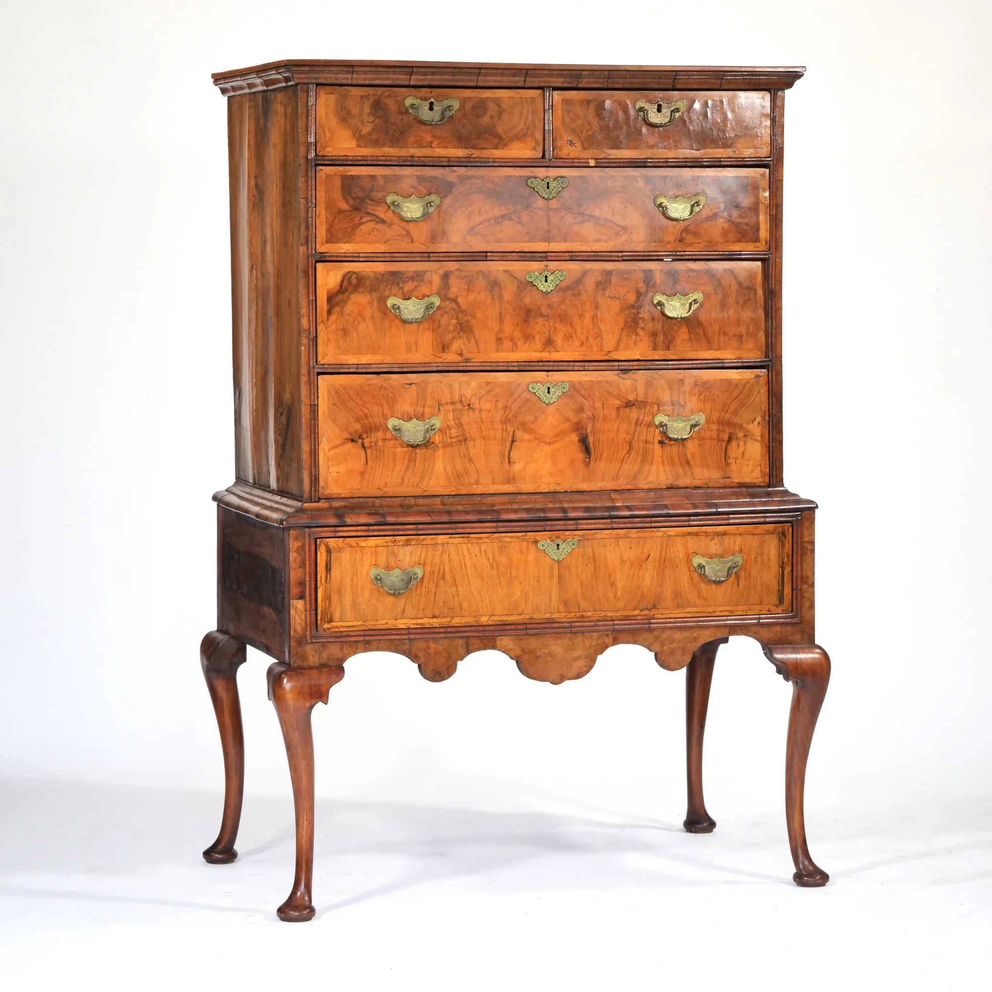 Antique wooden dresser with five small drawers on top and two larger drawers at the bottom, brass handles, curved legs, against a plain white background, auctioned and photographed by ACES Gallery.