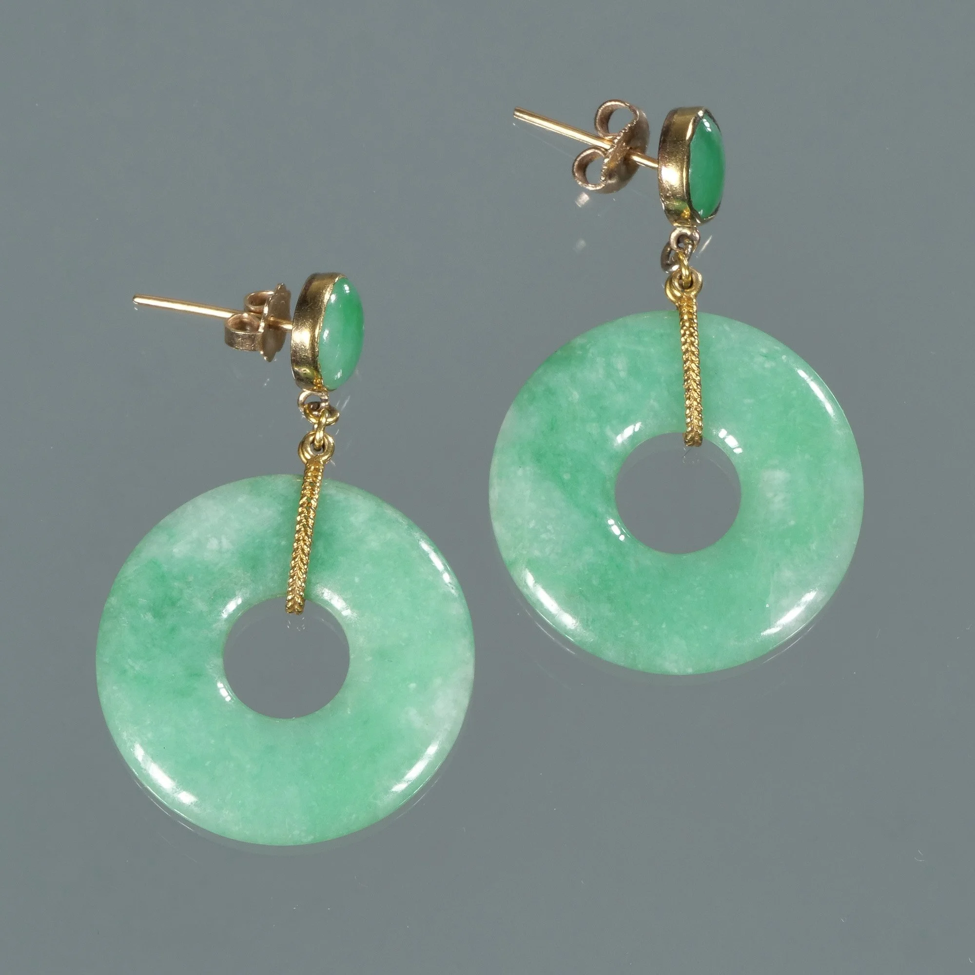 Green jade hoop earrings with gold accents and green stone embellishments on a gray background, auctioned and photographed by ACES Gallery.