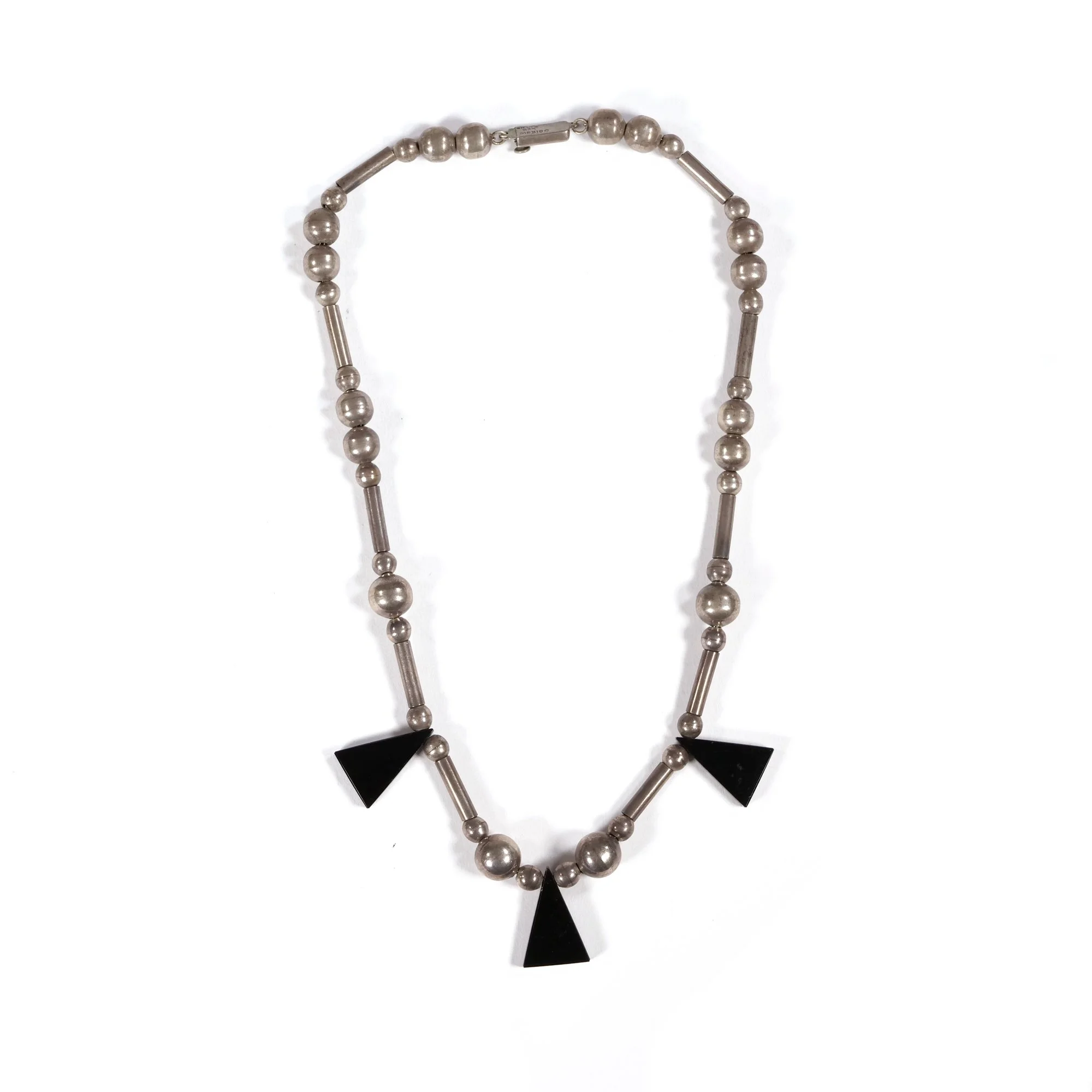 Necklace with alternating silver beads and three black triangular pendants, auctioned and photographed by ACES Gallery.