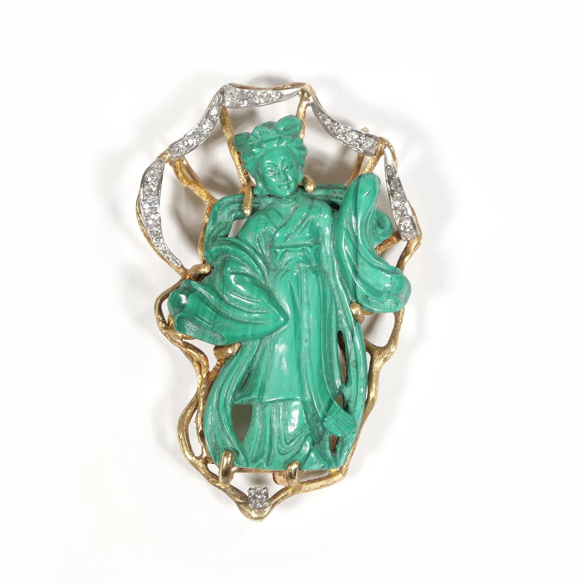 Gold and silver jewelry brooch with a green carved goddess figure, surrounded by a gold frame adorned with small diamonds, auctioned and photographed by ACES Gallery.
