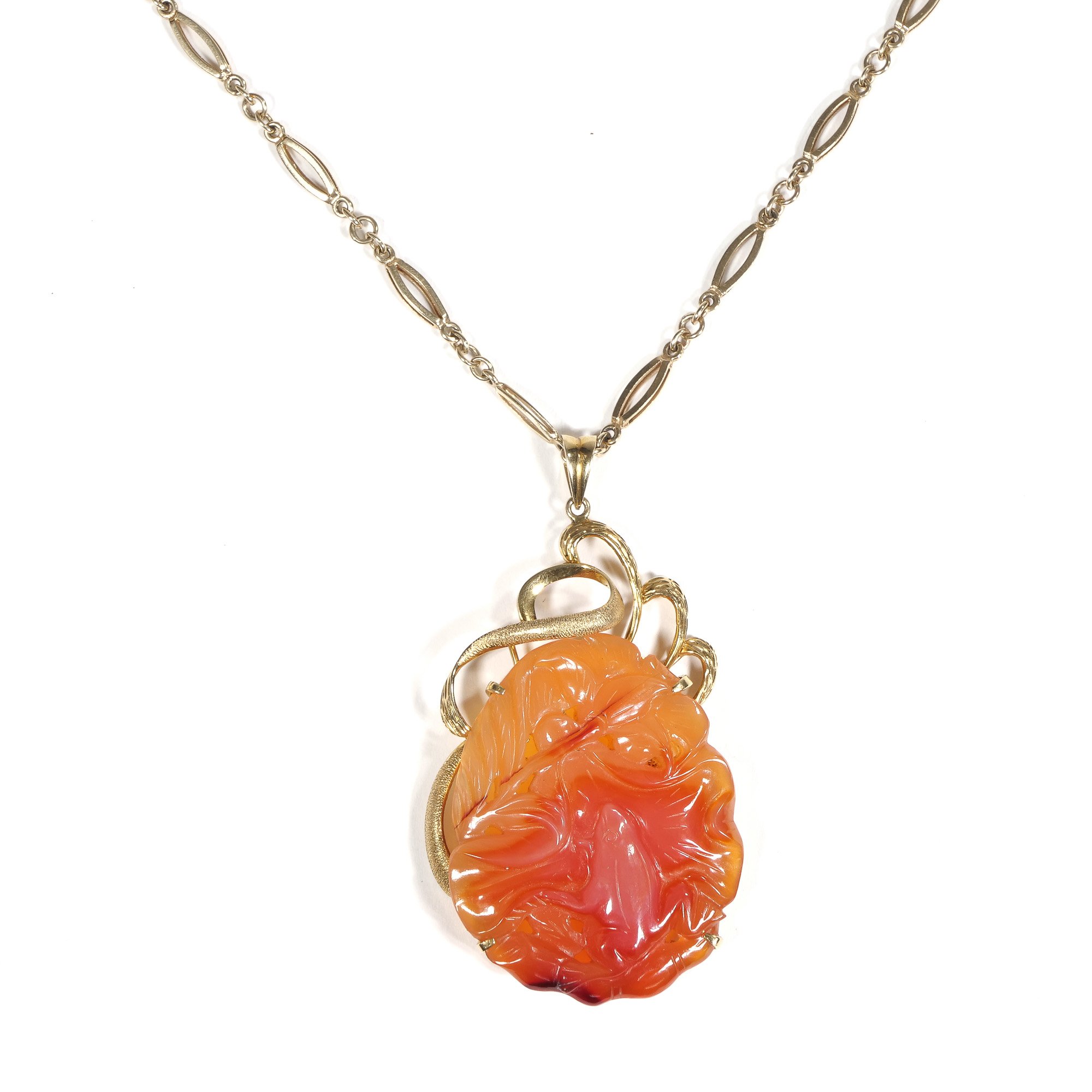 Gold chain necklace with an orange carved gemstone pendant, shaped like a flower, attached by a decorative gold-colored snake motif, auctioned and photographed by ACES Gallery.