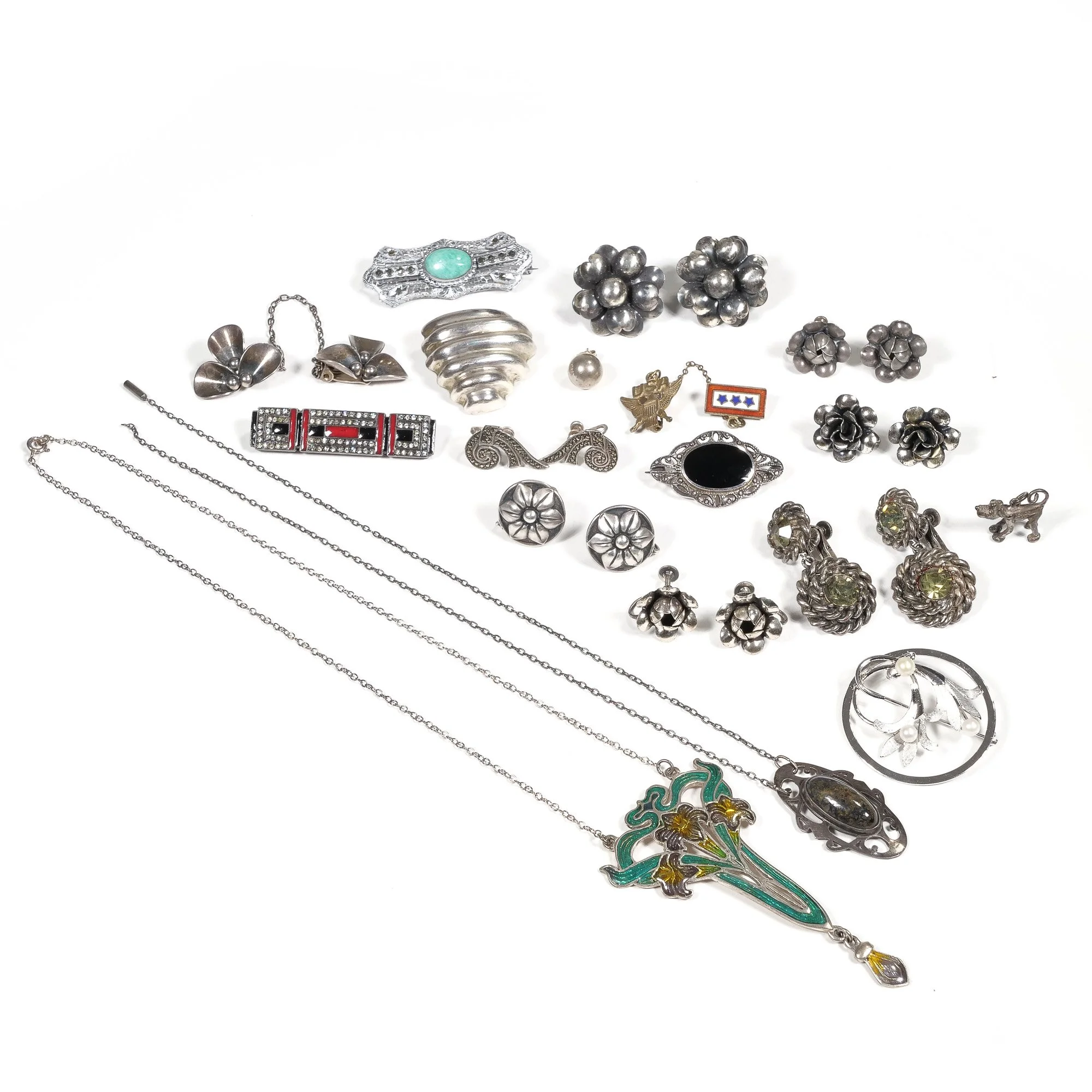 A collection of various vintage and costume jewelry including necklaces, earrings, brooches, and rings, arranged on a white background, auctioned and photographed by ACES Gallery.