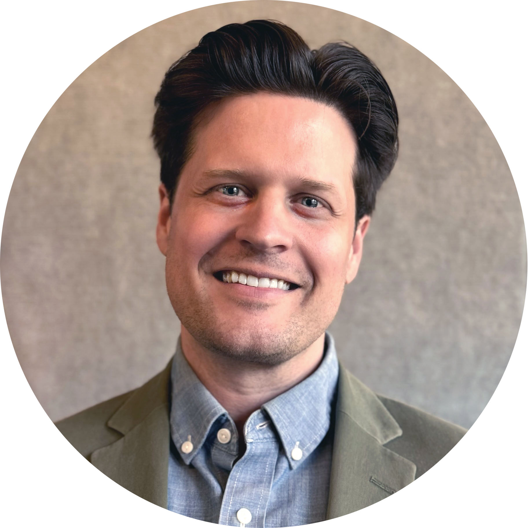 A portrait of Alex Fonarow, founder and owner of ACES Gallery, wearing a green blazer and a blue collared shirt, standing against a neutral background.