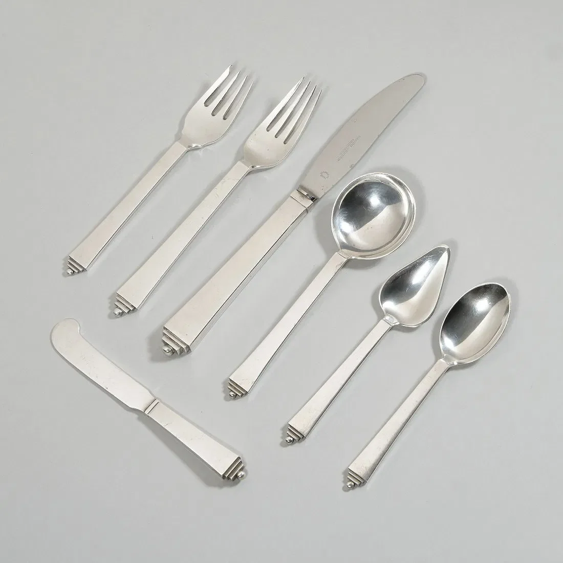 Georg Jensen sterling silver flatware in the "Pyramid" pattern, auctioned and photographed by ACES Gallery.