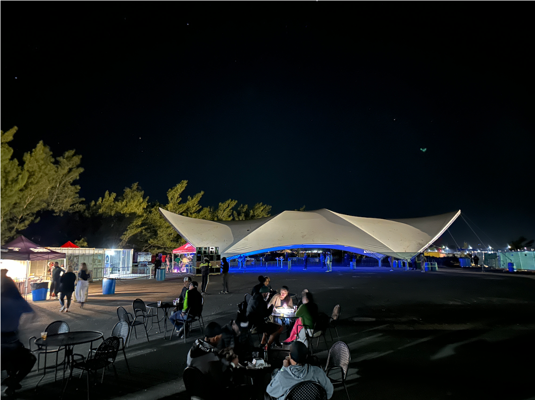 Nighttime view of the PTIX Pavilion event venue at Clearwater Beach Bermuda, illuminated for evening events with ample outdoor space, parking, and vendor areas