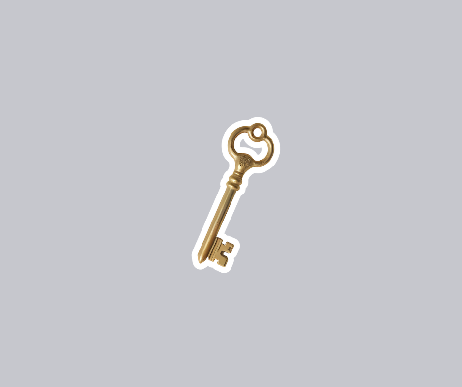A small gold key with a round handle and ornate bit on a gray background.