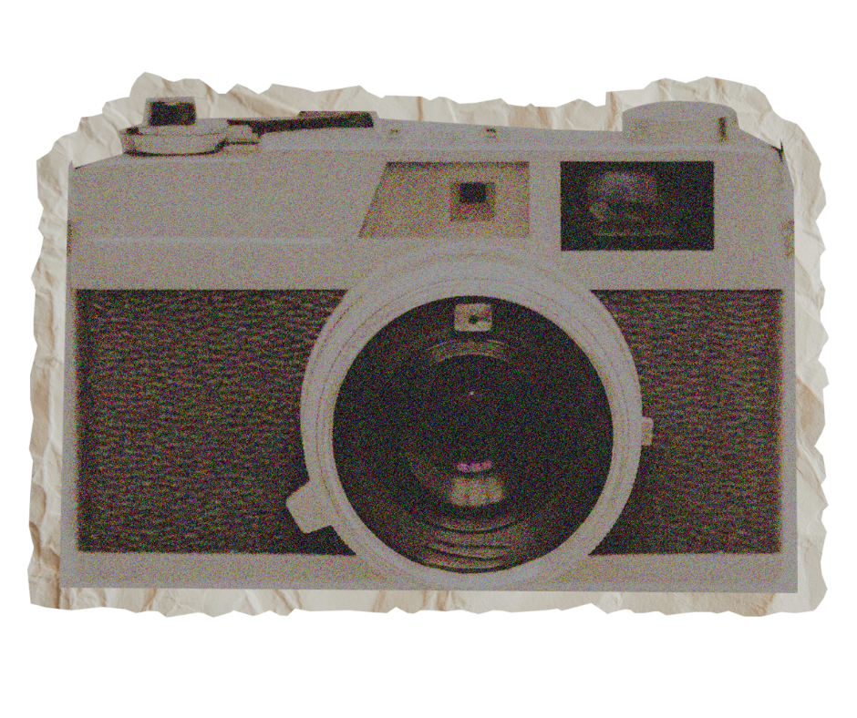 A vintage camera with a large lens, viewfinder, and textured black and white body, placed on a red surface.
