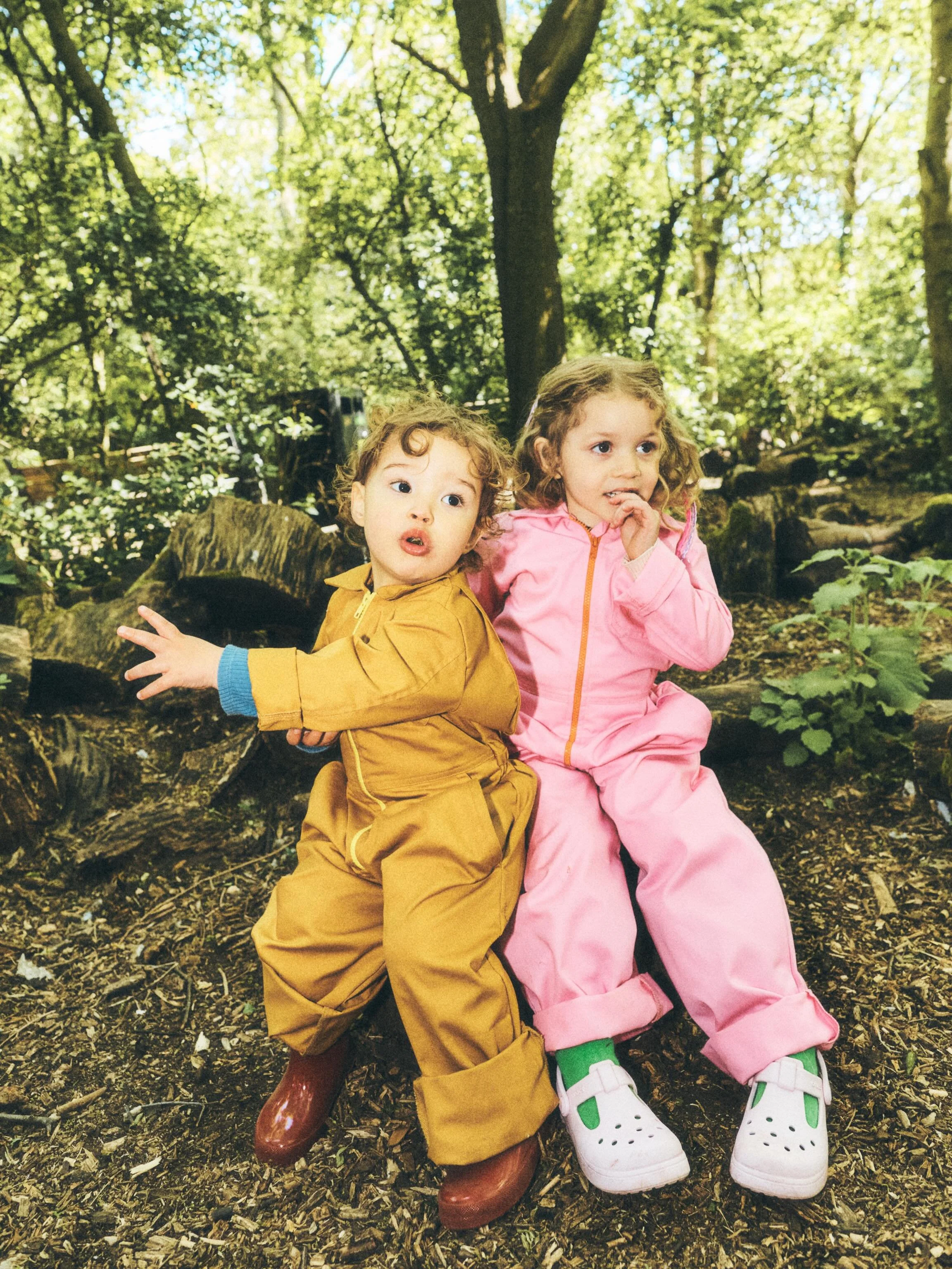 SS26 is here 👀 🩷💛
Koa + Awala in 
Mustard yellow + Candy pink cotton drill boilers 

Shot by @leoniefreemanphoto 
Styled by @kim_howells 
Wellies @hunterbootsuk *pr 
Crocs @schuhpr *pr 

#playingout #madeformischief #newss26drop #kidsboilers