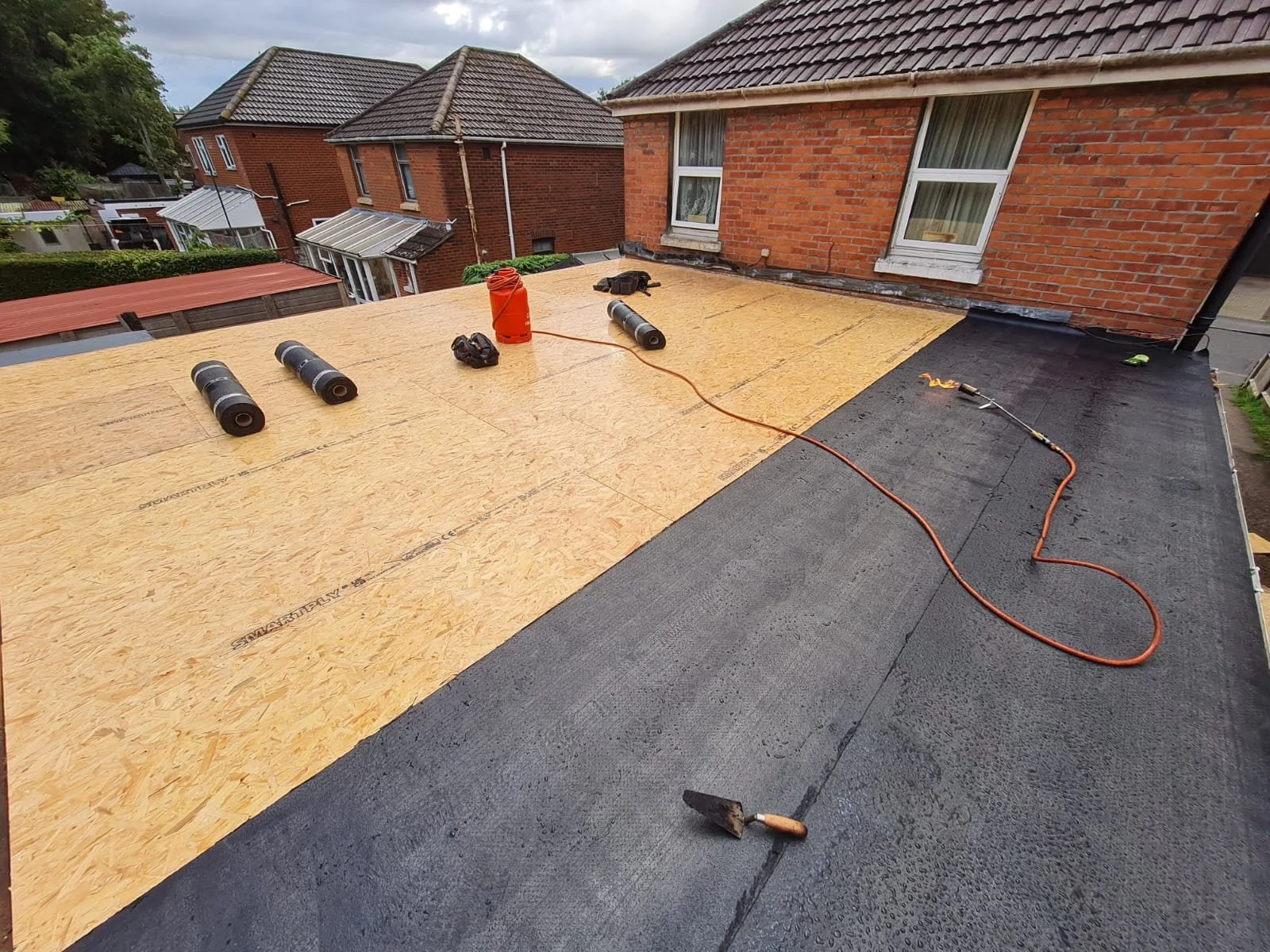 Modern flat roof with correct drainage fall on a house extension