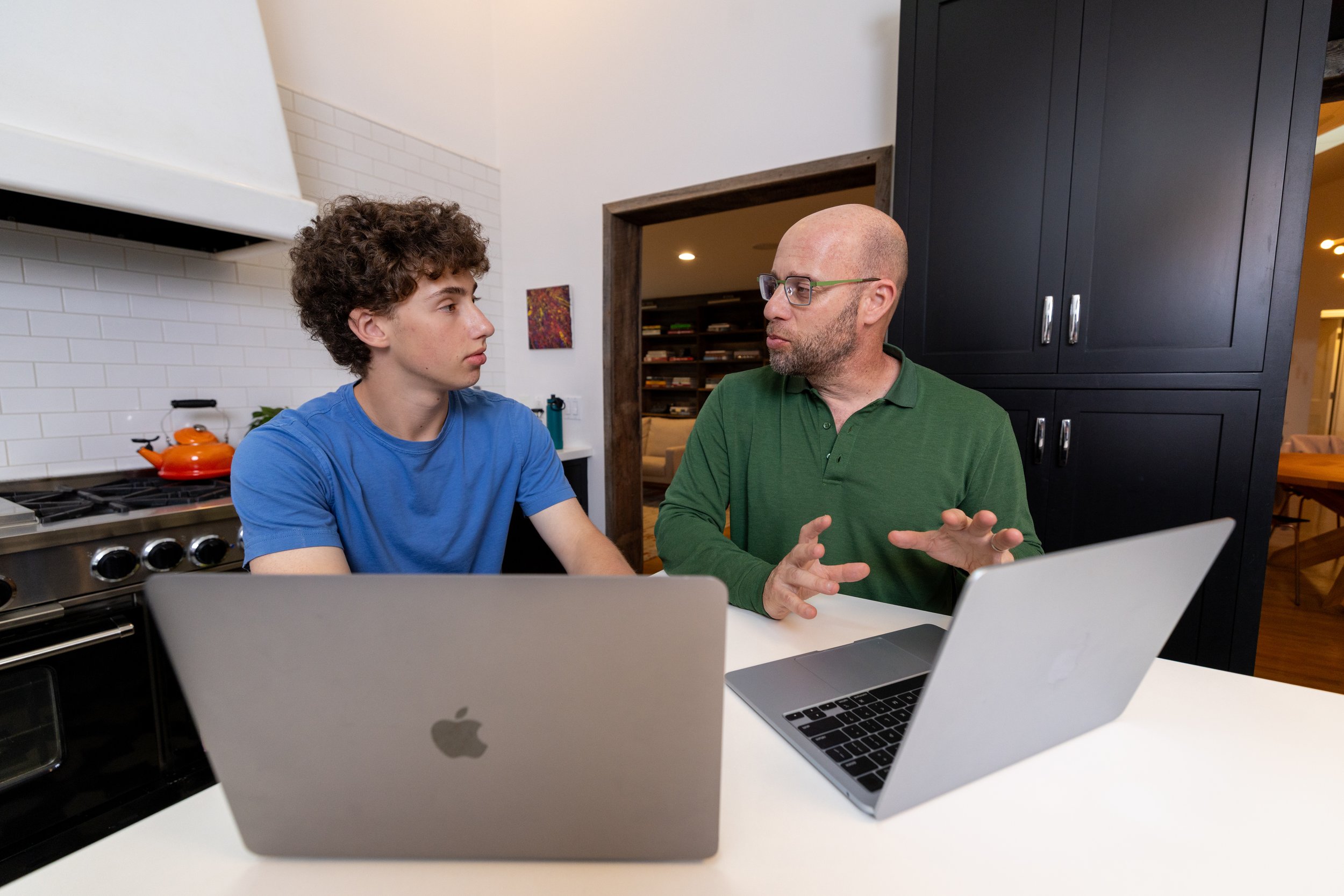 Writing teacher coaches teen writing student