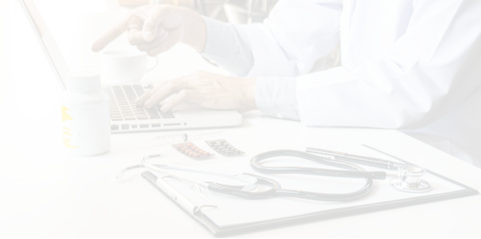 Doctor in white coat using a laptop at a white desk with a clipboard, stethoscope, and medication bottles.