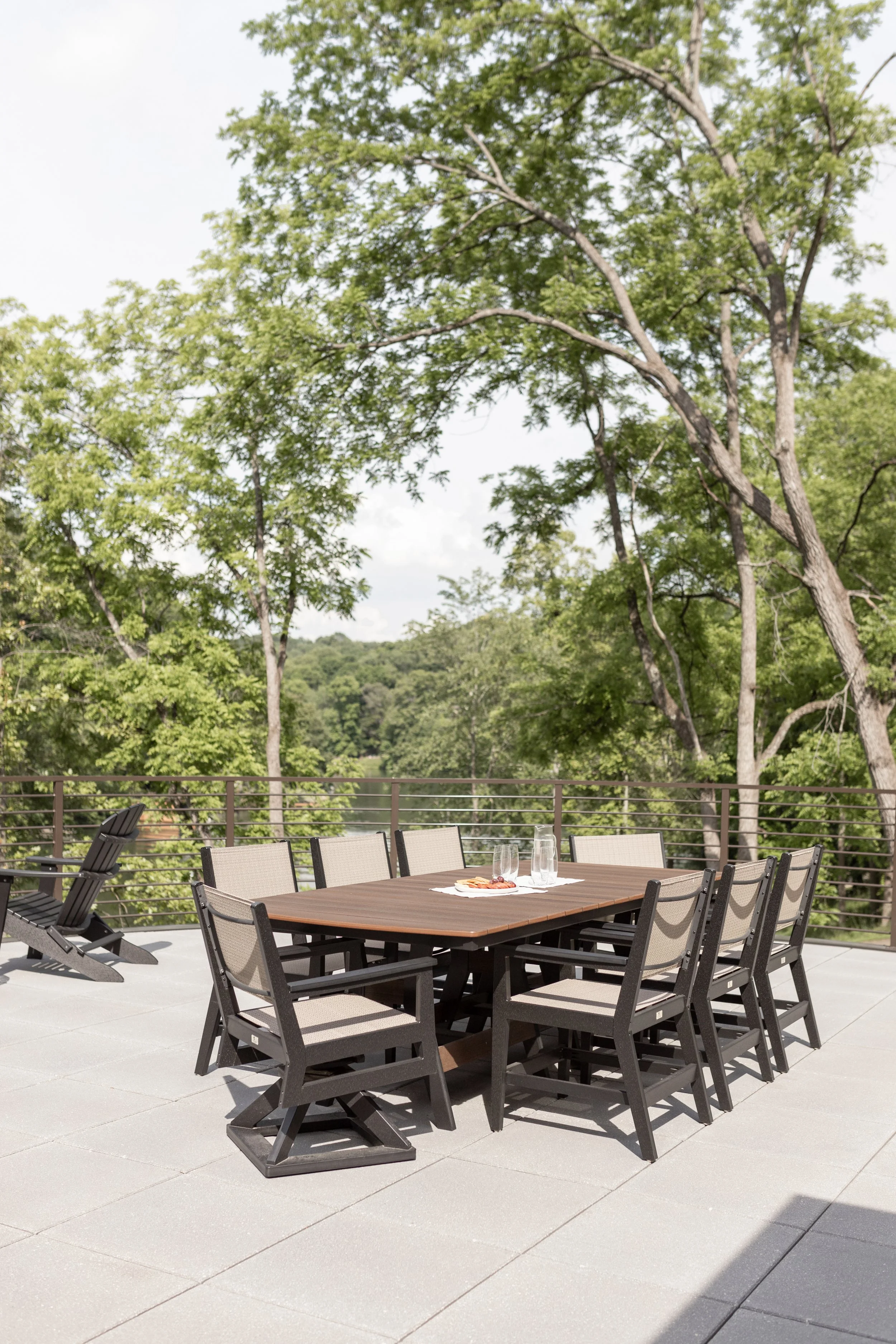 Harbor 44” x 96” Rectangular Dining Table in Brazilian Walnut on Black. Mayhew Sling Dining Swivel Rocker and Mayhew Sling Dining Chairs in Black, sling in Elevation Stone.jpg