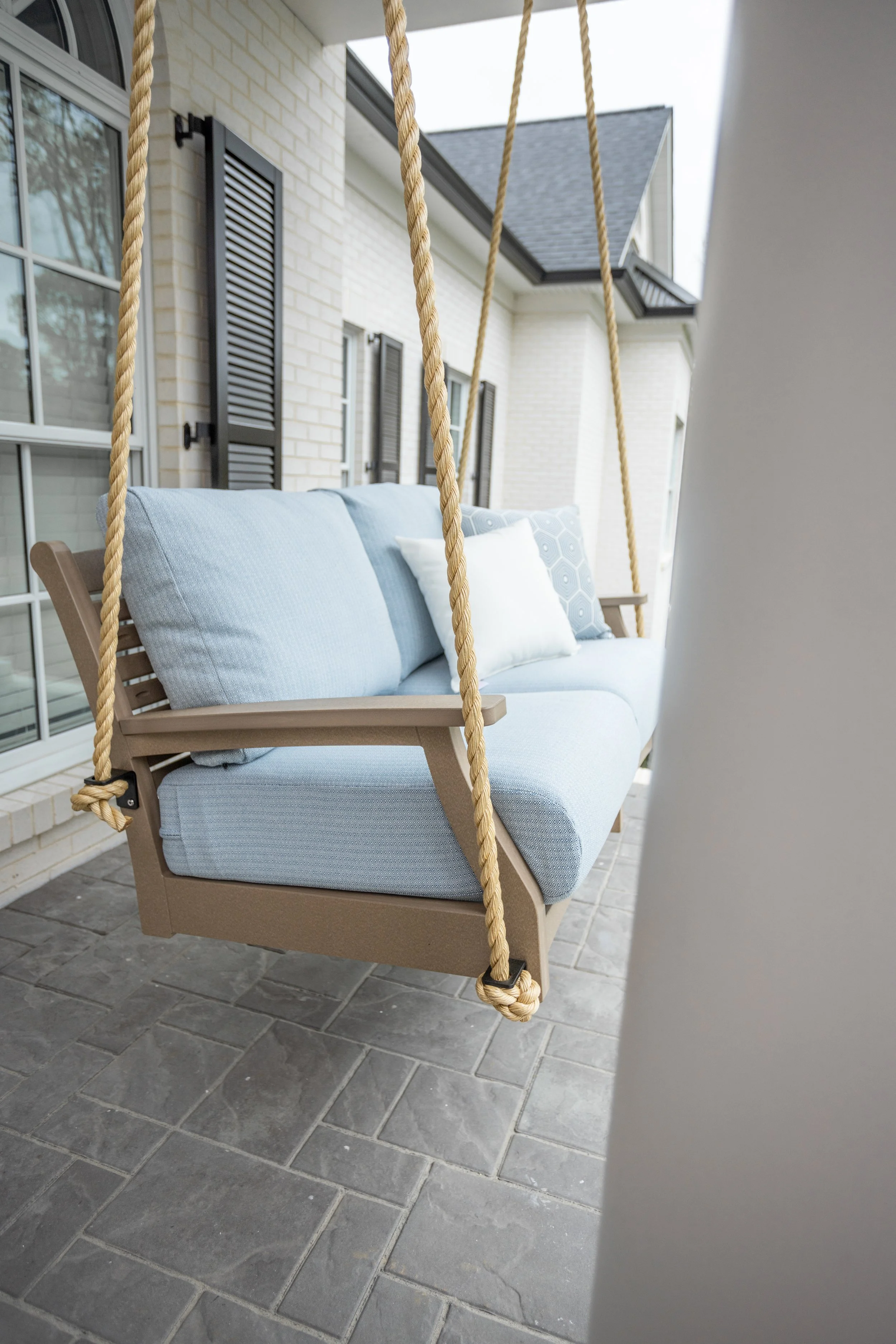 Classic Terrace loveseat swing in weatherwood. Cushions in Nude Beach Skt. Pillows in Canvas natural and Schooner sky.jpg