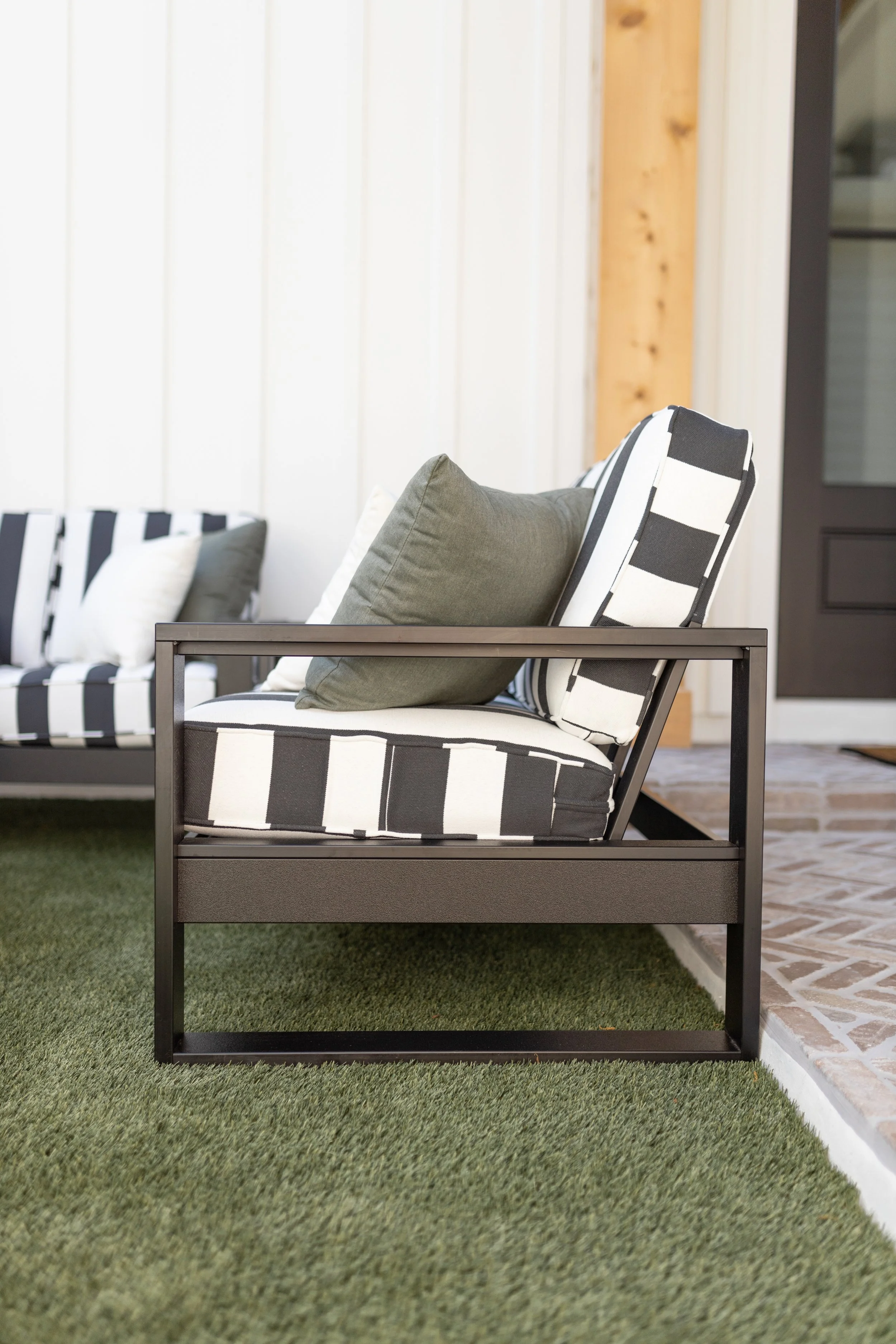 Nordic High Back Loveseat in Matte Black. Cushions in Galleon Ebony with throw pillows in Cast Sage, Canvas Natural.jpg