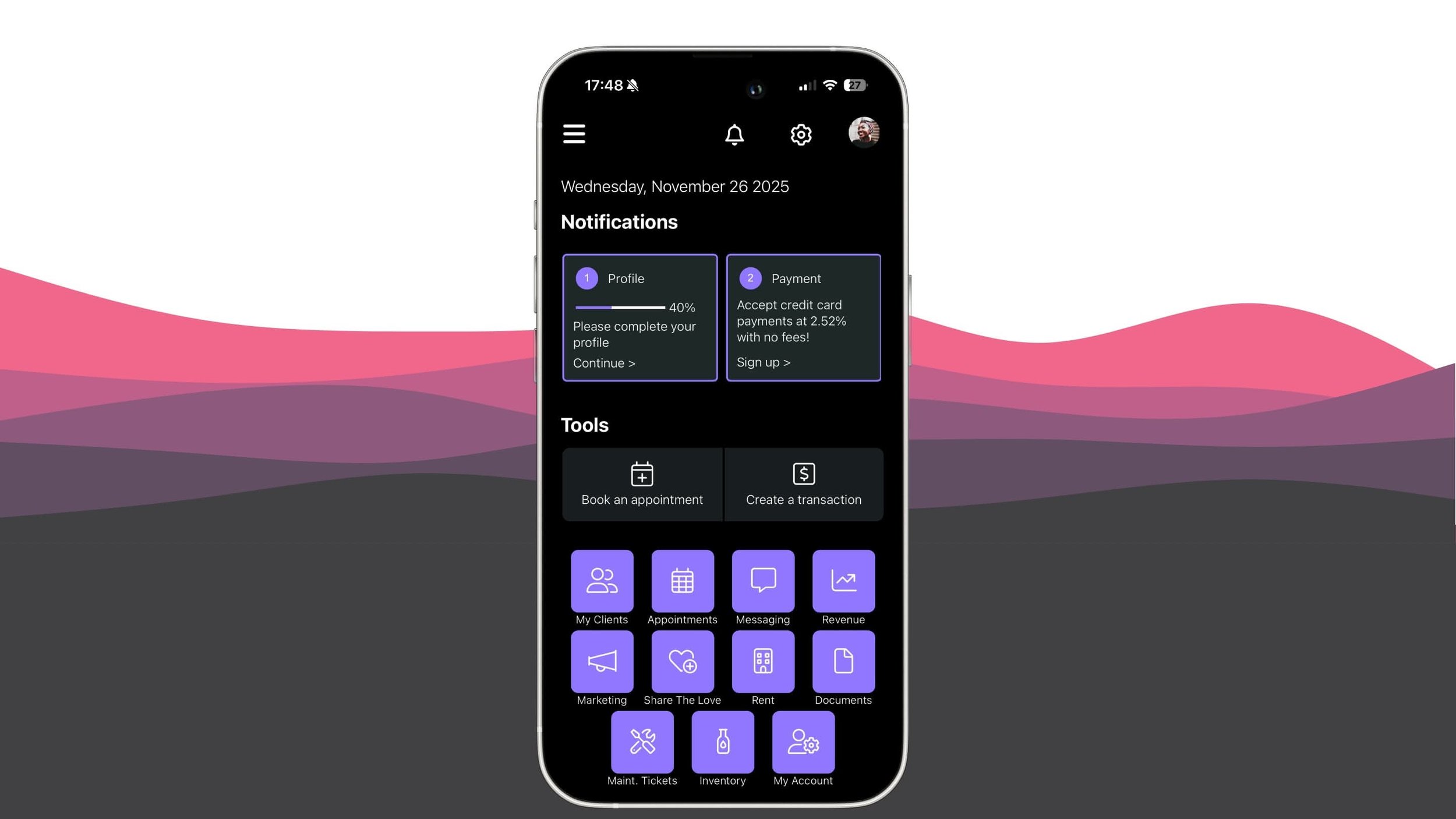 A smartphone displaying a dark-themed app interface with notifications, tools, and various icons for client management, appointments, messaging, revenue, marketing, sharing, rent, documents, tickets, inventory, and account settings.