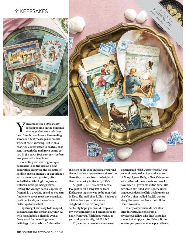 Vintage postcards and photographs on a tray with seashells and pink background, featuring scenes of ladies at the beach and maritime themes.