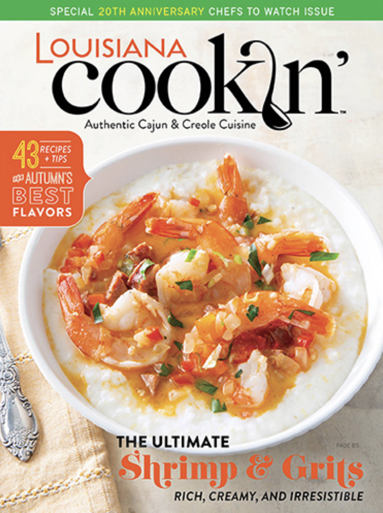 Cover of Louisiana Cookin magazine featuring a shrimp and grit dish with shrimp, tomatoes, green onions, and seasonings in a white bowl.