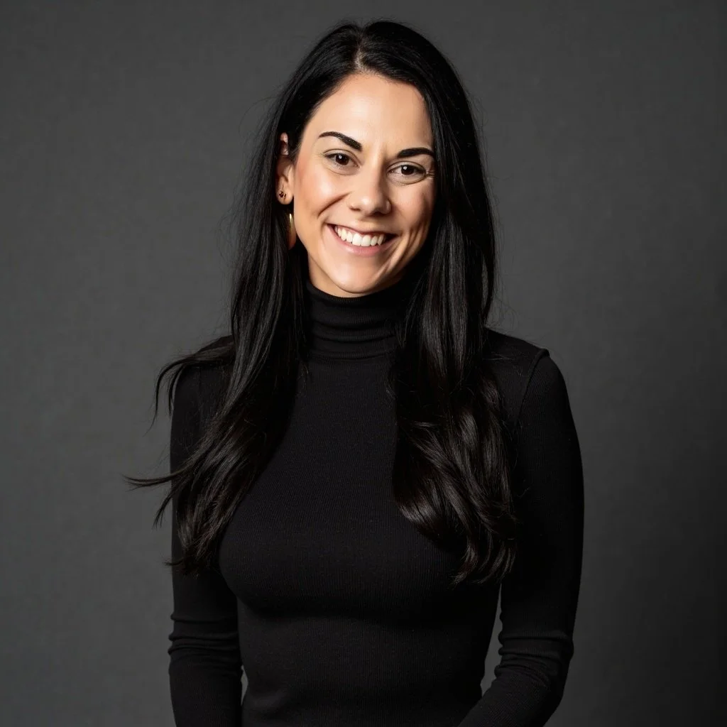 A woman with long black hair, smiling, wearing a black turtleneck sweater, against a dark background.