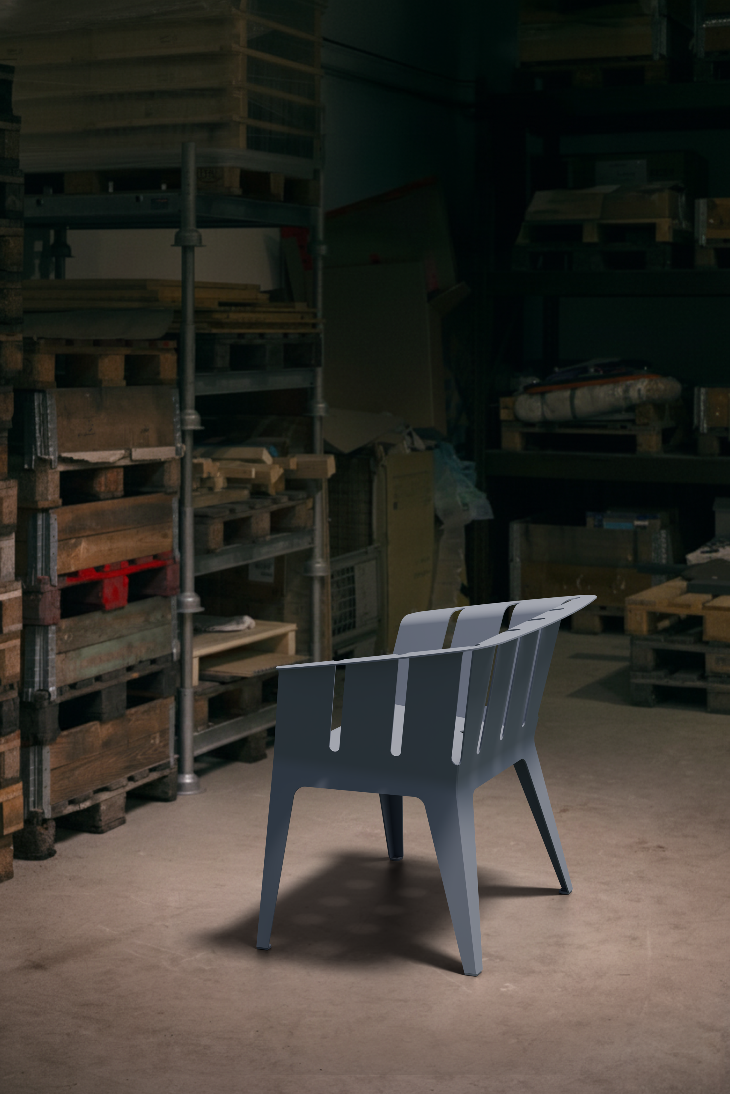 Ein moderner grauer Sessel in einem Lagerraum mit Holzpaletten und Regalen im Hintergrund.