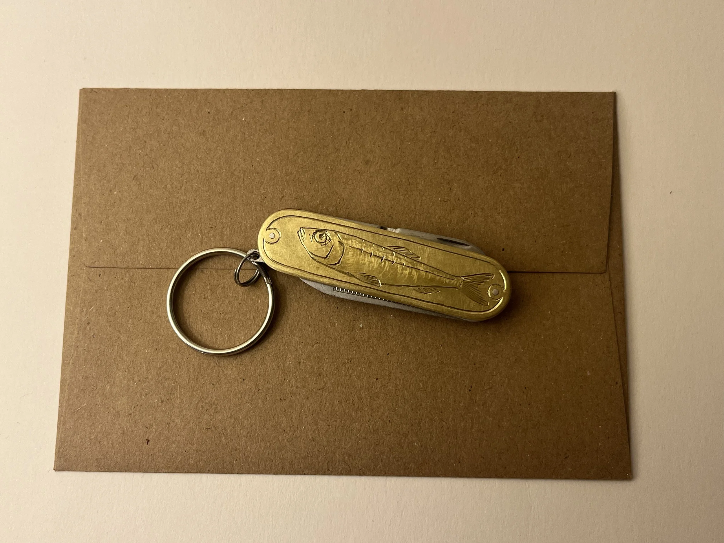 Hand engraved fish on a pocket knife Montpelier VT